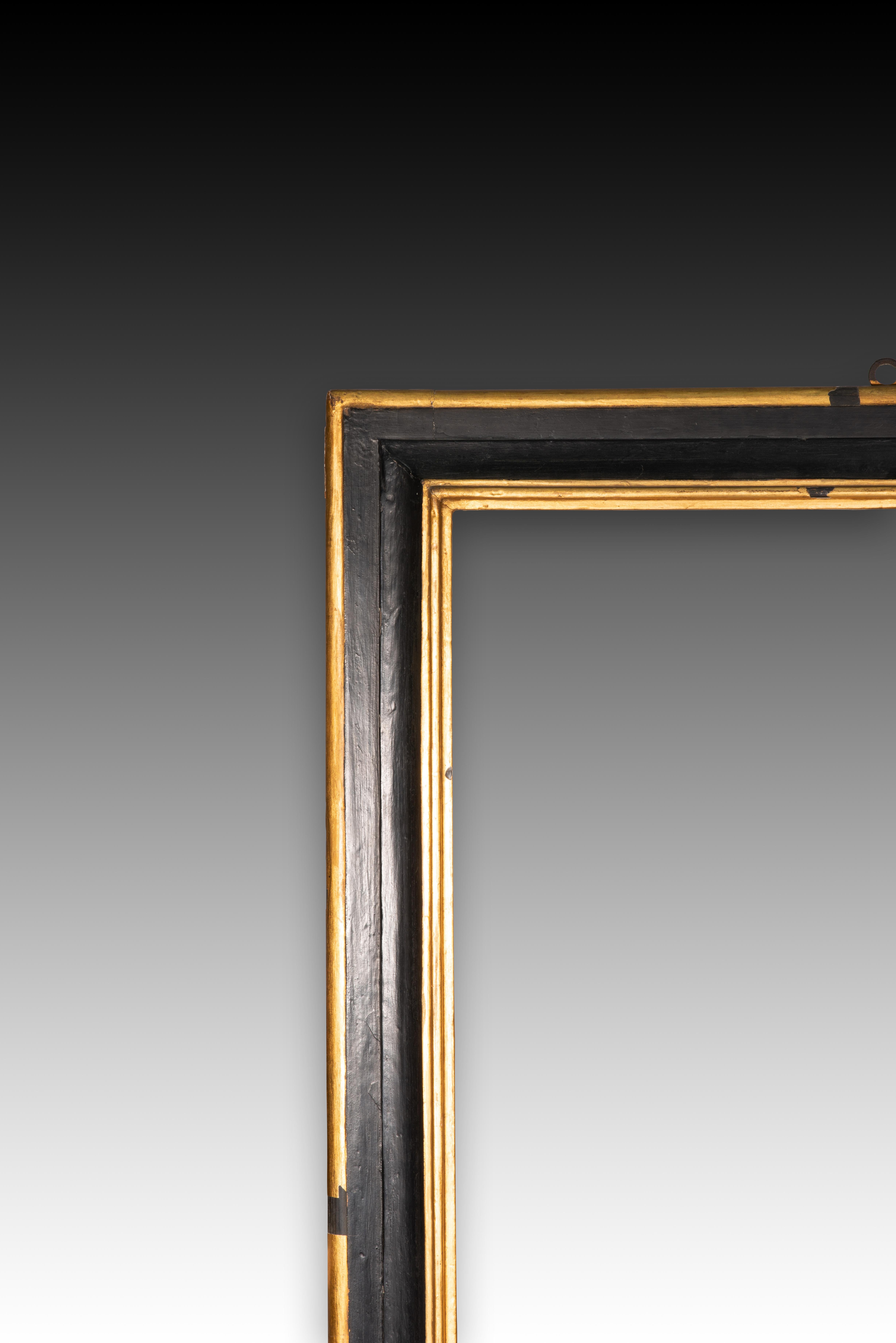 Frame. Carved, polychrome and gilded wood. 18th century.
 It has faults. 
Rectangular frame made of carved wood with a black area flanked by two gold areas on the outside and inside of the piece, with a flat area in both colours and another