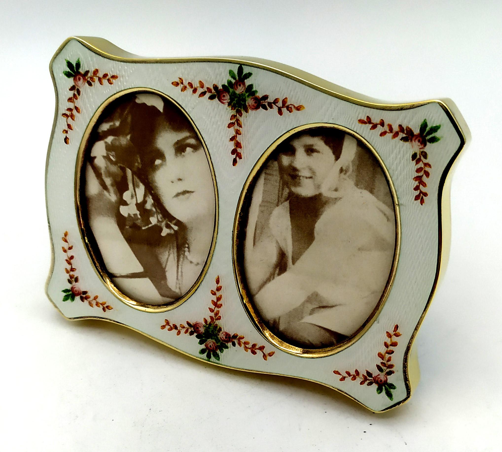 Shaped frame for 2 photographs in sterling Silver 925/1000 gold plated with translucent fired enamels on guillochè and hand-painted floral miniatures. Viennese Art Nouveau style second half of the 19th century. Blue velvet panel. External measures