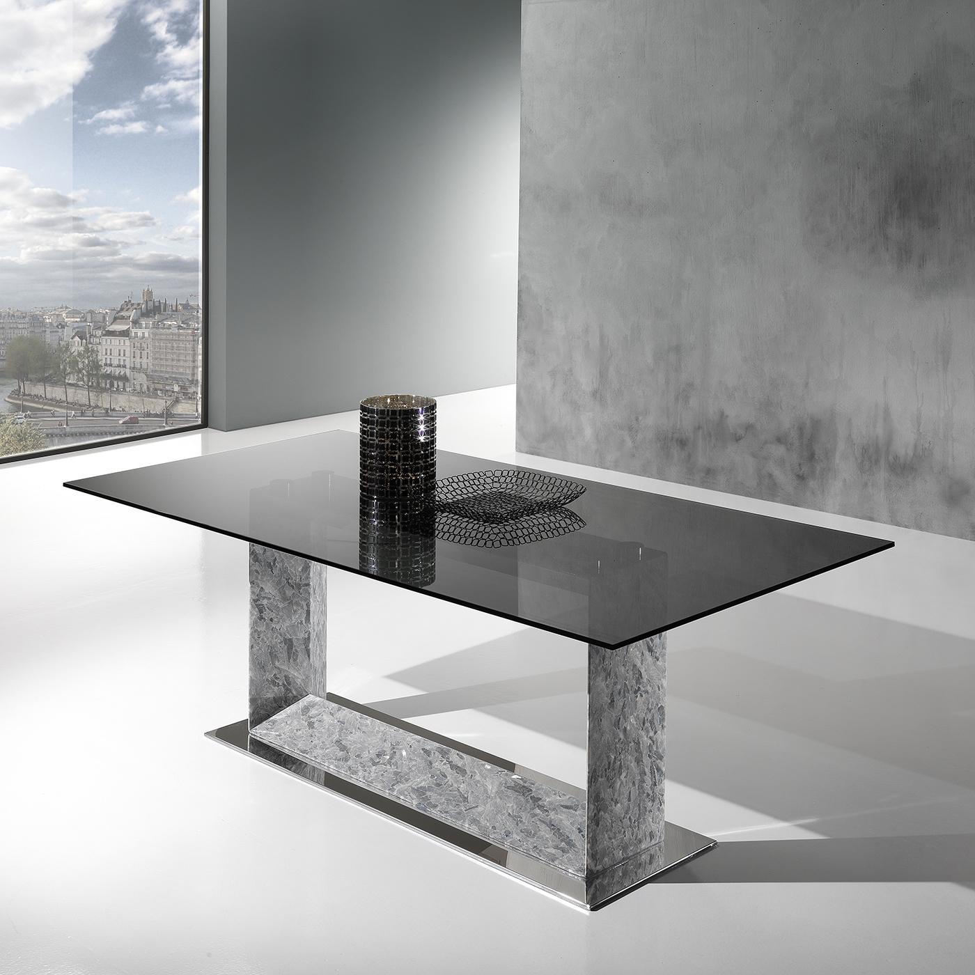 This superb rectangular dining table combines a modern, essential design with traditional, Italian stone-carving artisanship. The U-shaped base - raised on a polished stainless steel rectangular plate - is handcrafted of Crystal Stone®, a rare,