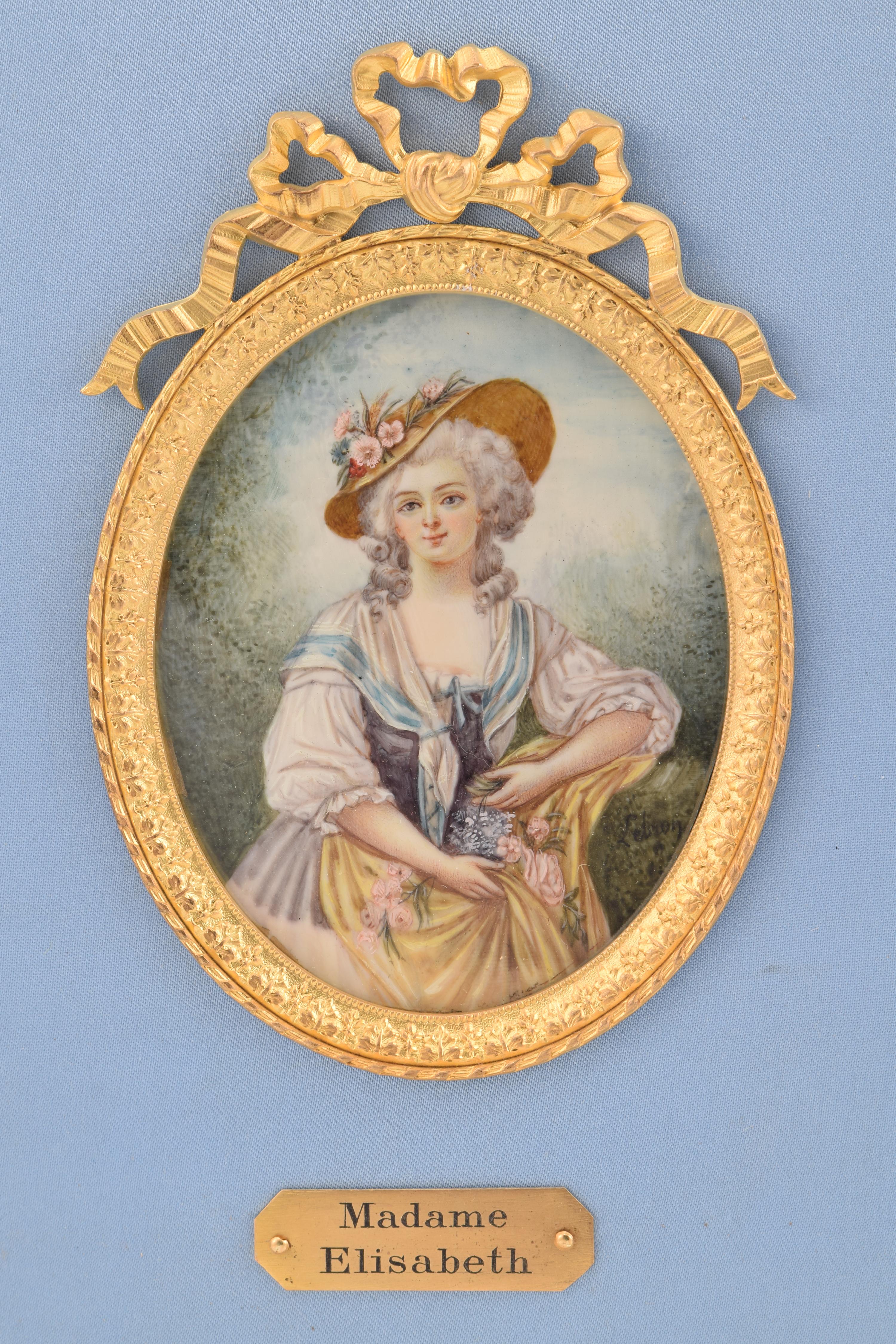 Frame with three miniatures. XIX century. 
Rectangular frame with a textile background that shows three oval miniatures with female portraits, enhanced with gilded bronze frames (the sides are finished with lacework, the central one crowned). The