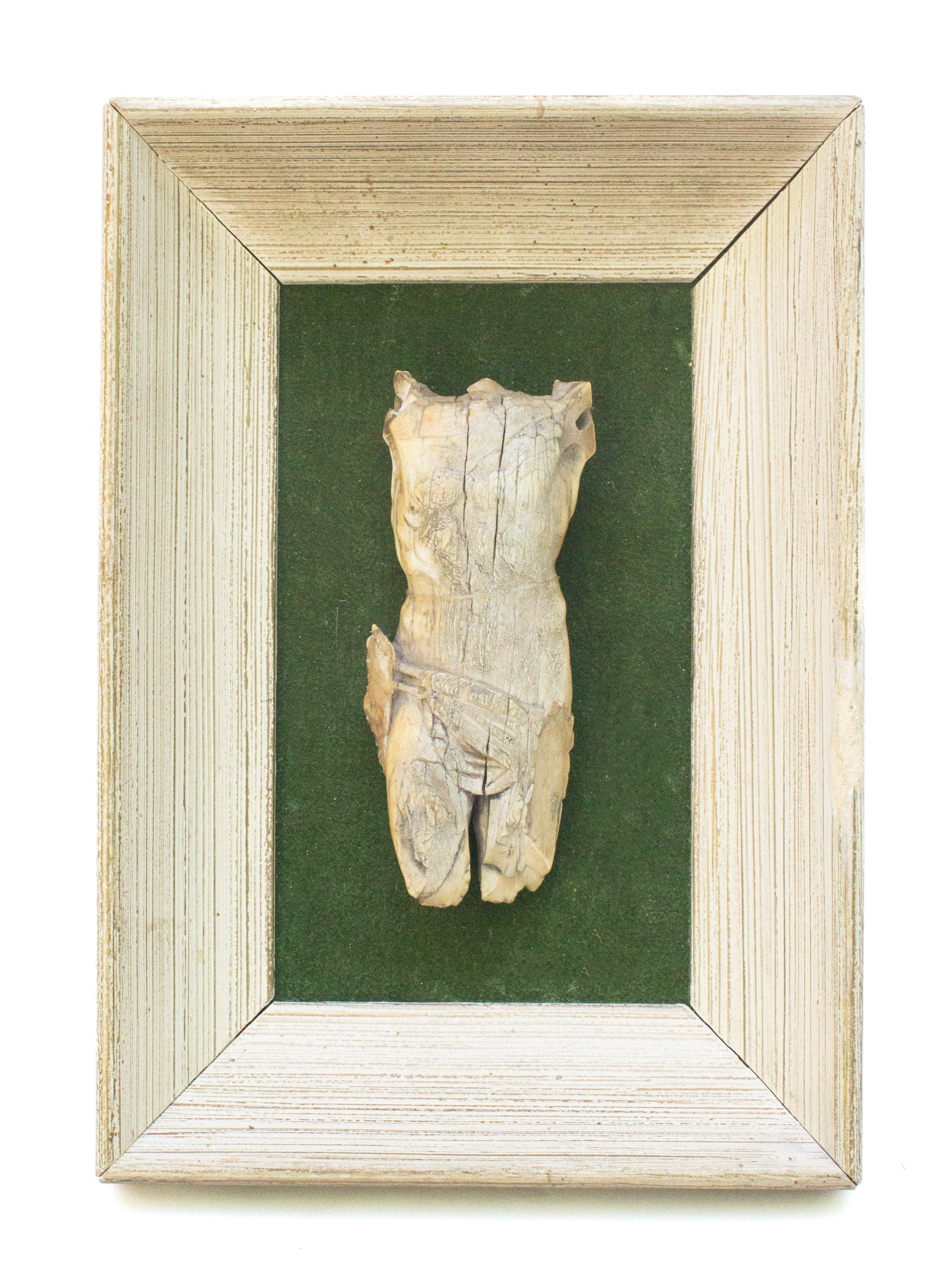 16th century Italian ivory figure of Christ mounted against green felt fabric and framed in a coordinating cream frame.

This piece was once originally part of a crucifix. The broken figure of Christ has been mounted onto the green backing and