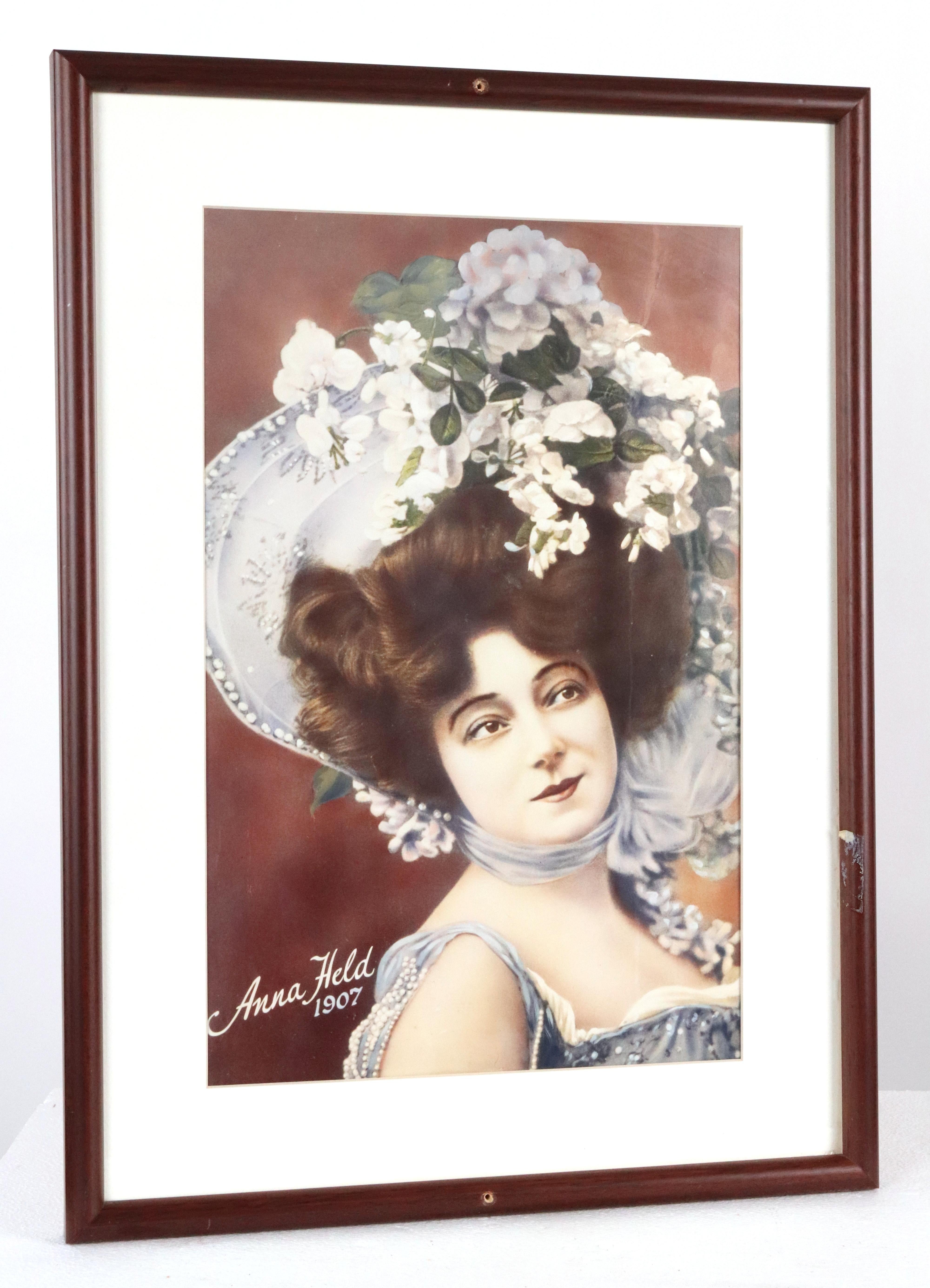 Framed print of Anna Held in 1907 from Gallagher's Steakhouse Restaurant in New York City. The frame is made of dark tone wood with glass. Good condition with surface wear from prior use. There are two predrilled holes for mounting. One available.