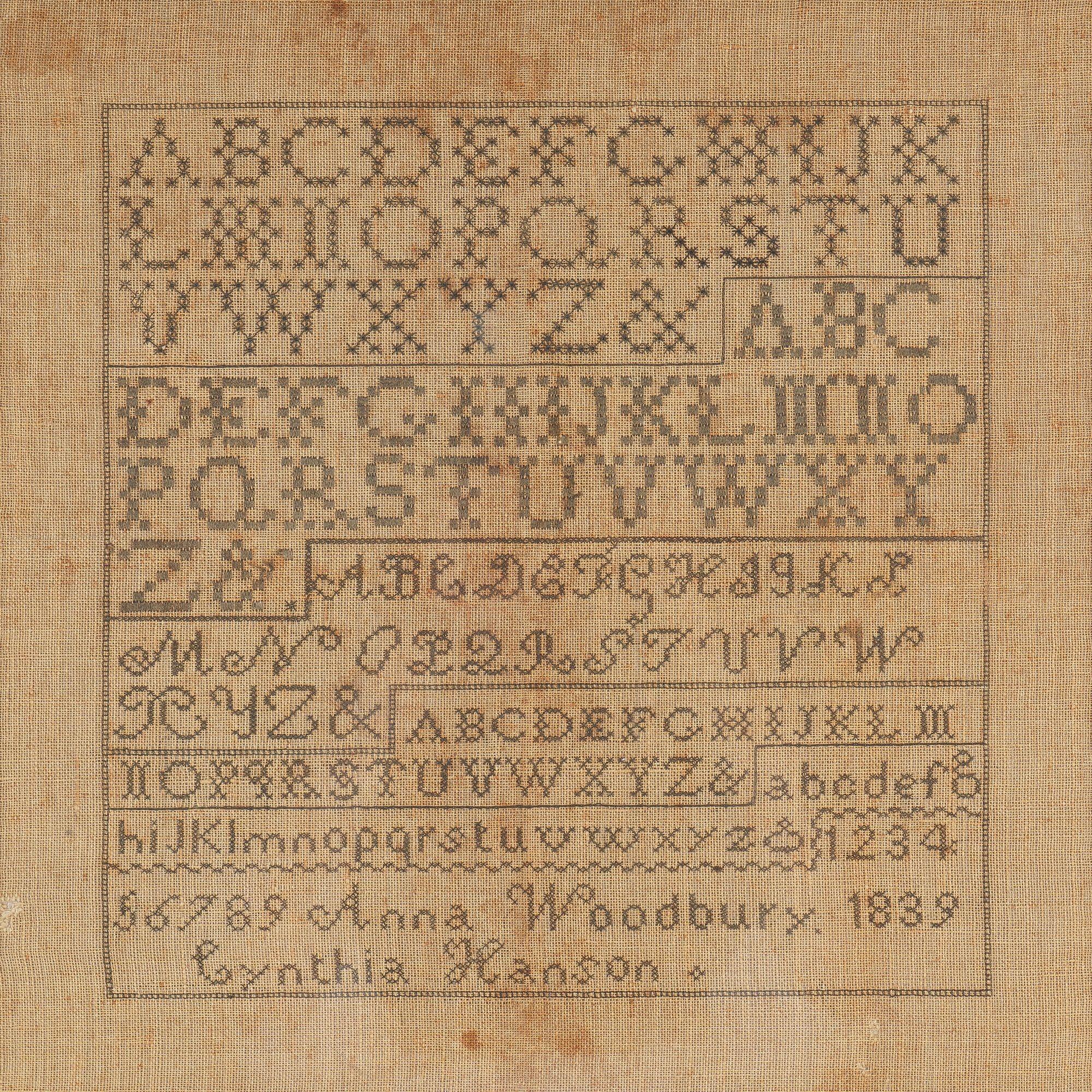 American marking sampler, featuring five sample alphabets and a numerical progression in contrasting styles and stitch. The sampler was stitched by Anna Woodbury, born 1839, and assisted by instructor Cynthia Hanson, born Cumberland, Maine in 1804.