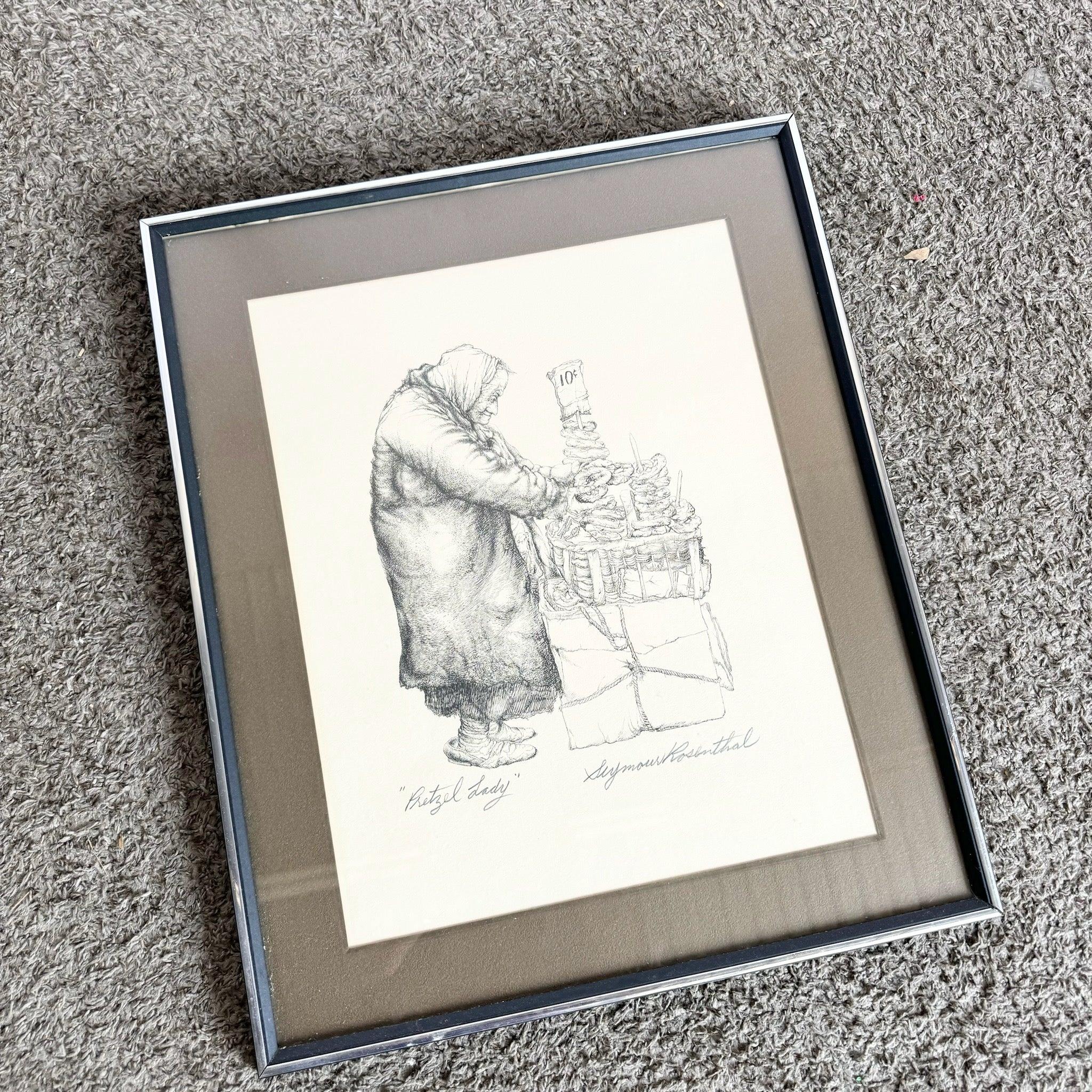 Framed and Signed Pretzel Lady Lithograph by Seymour Rosenthal—detailed depiction of a street vendor, signed and numbered.​
 
 We sell items as acquired, without restoring or repairing. Vintage pieces may have age-related wear. Review photos