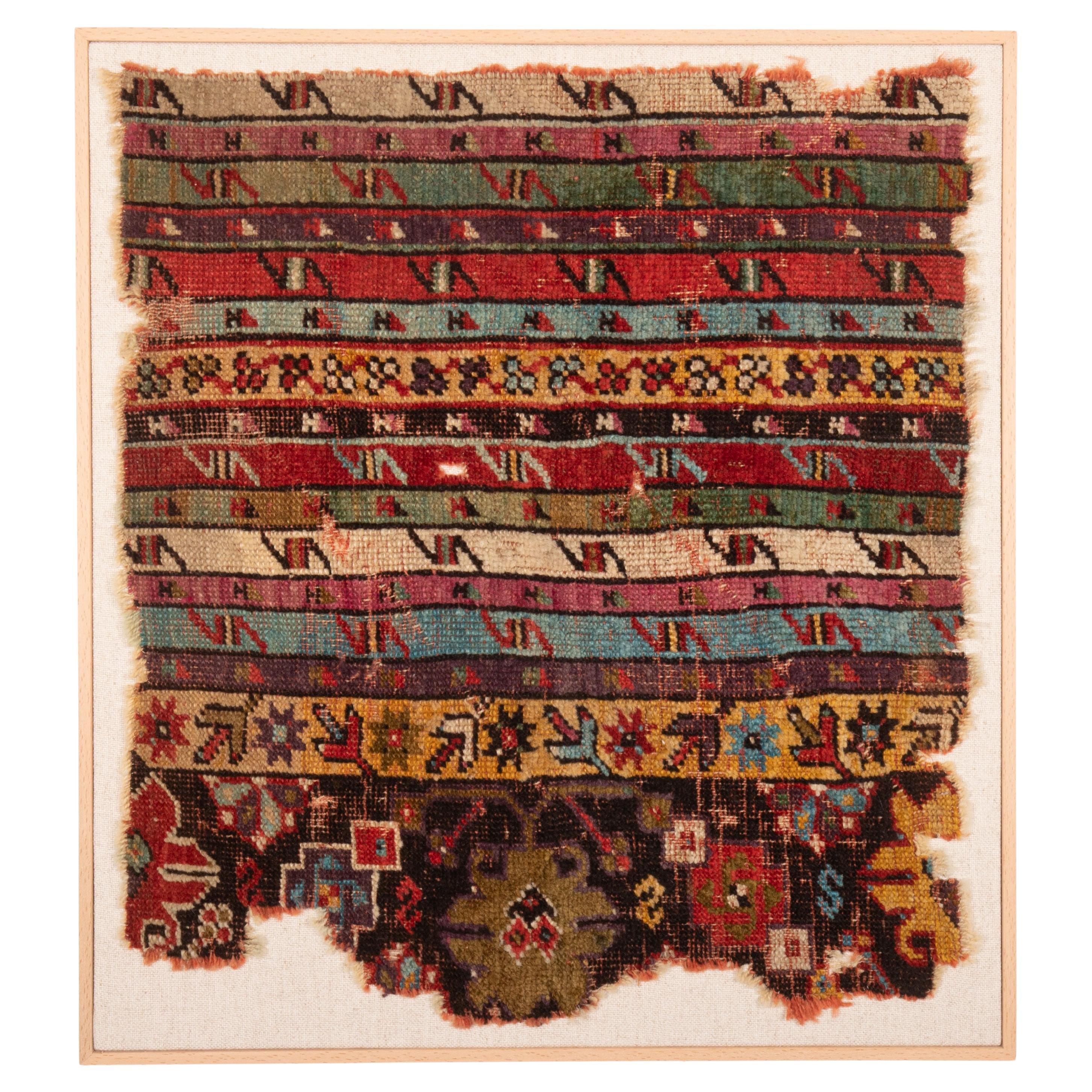 Fragment de tapis d'Anatolie ancien encadré, 19e siècle