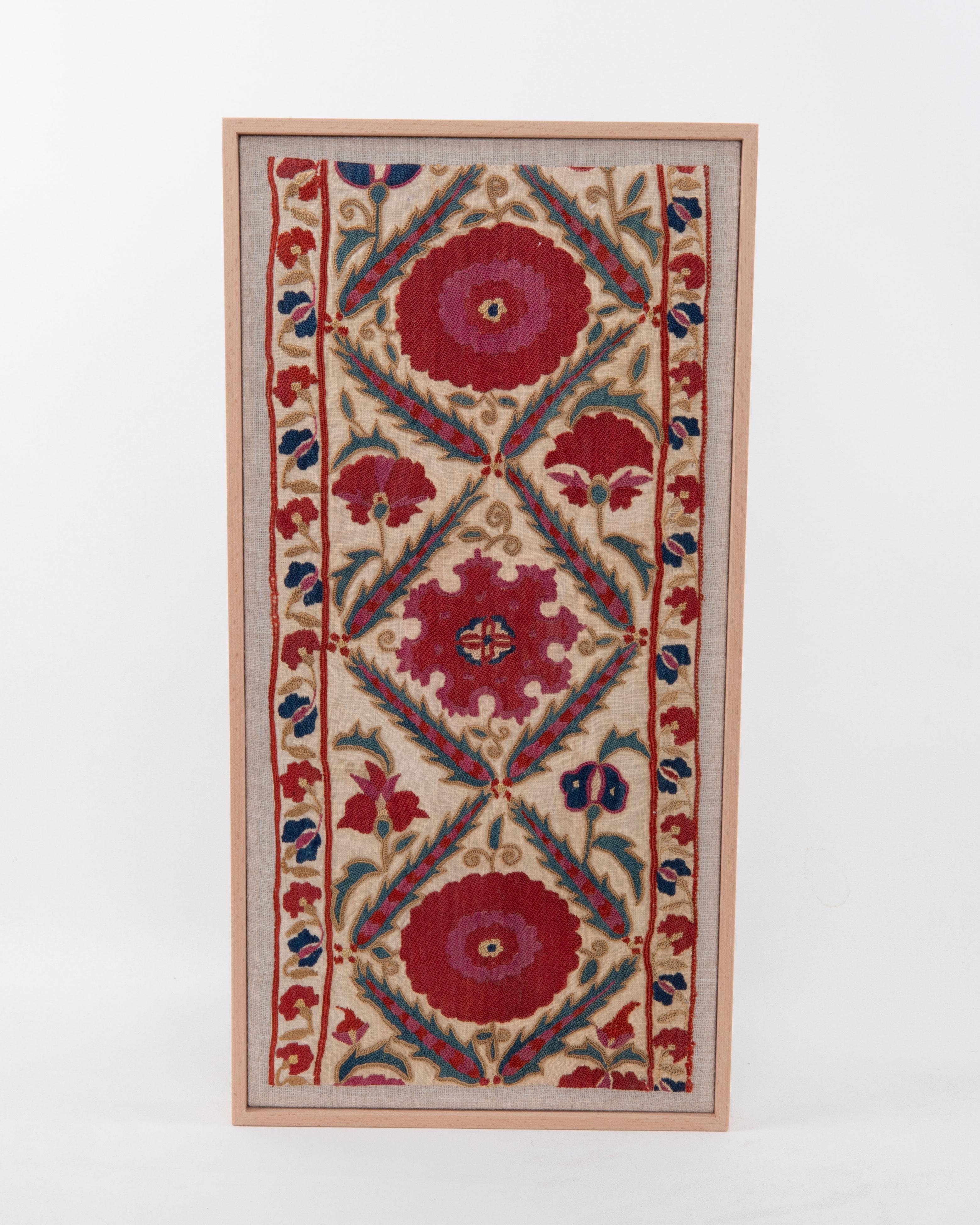 First the fragment has been hand backed on a linen fabric, then stretched over a wooden stretcher and finished with a wooden frame.
Late 19th C. Uzbekistan
Ready to go on a wall.

Framed Item above is made from a used and antique embroidery