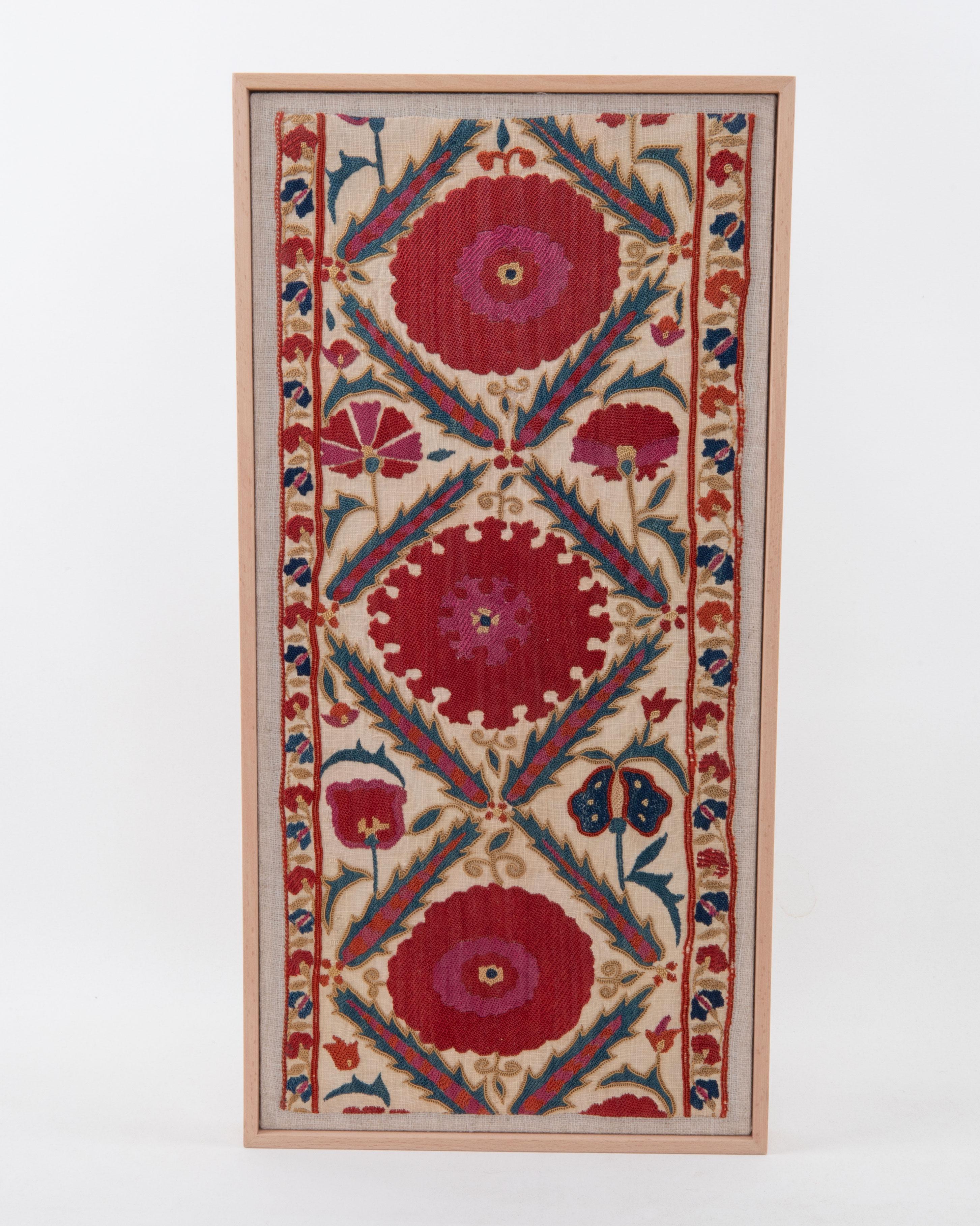 First the fragment has been hand backed on a linen fabric, then stretched over a wooden stretcher and finished with a wooden frame.
Late 19th C. Uzbekistan
Ready to go on a wall.

Framed Item above is made from a used and antique embroidery
