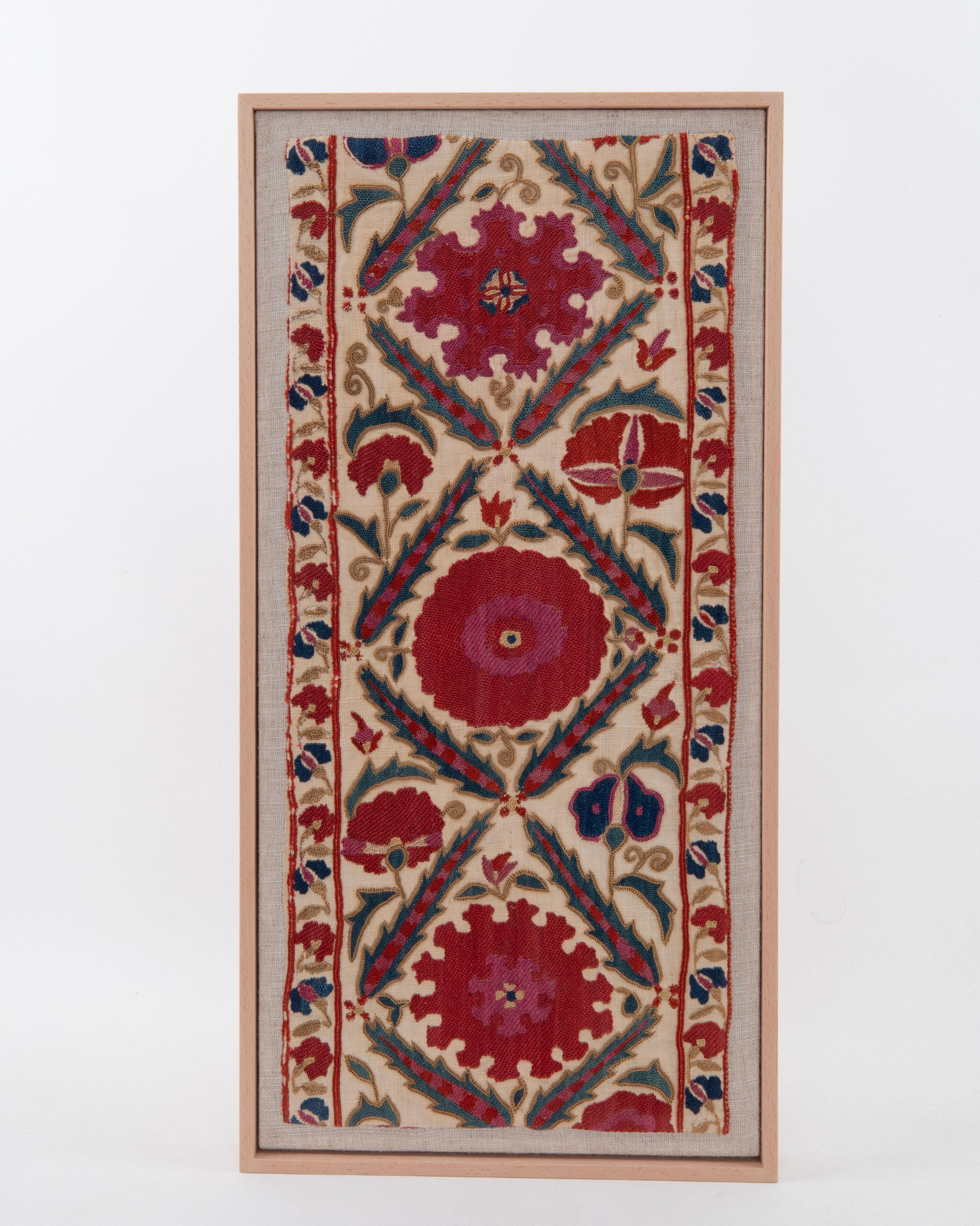 
First the fragment has been hand backed on a linen fabric, then stretched over a wooden stretcher and finished with a wooden frame.
Late 19th C. Uzbekistan
Ready to go on a wall.

Framed Item above is made from a used and antique embroidery