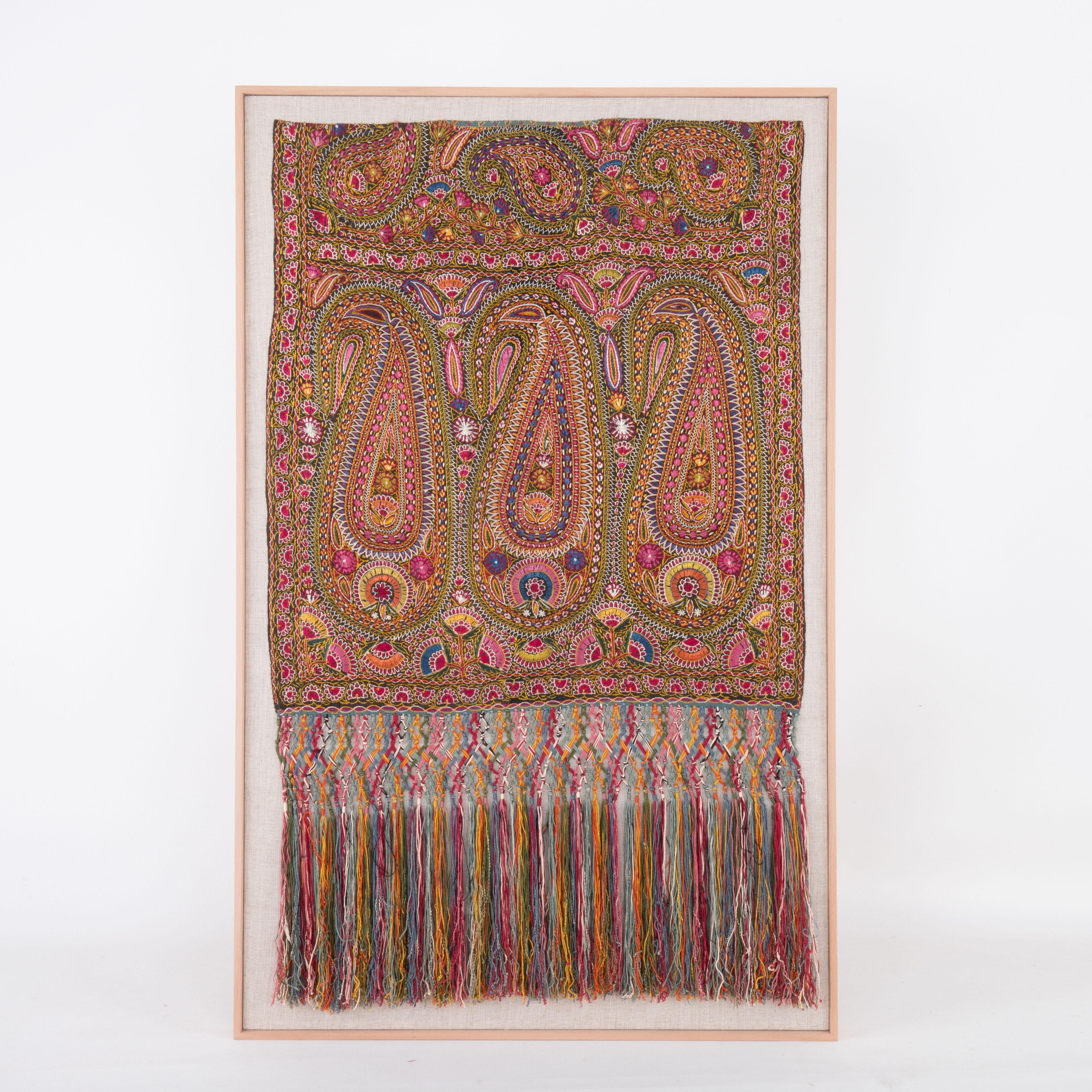 It is finely embroidered in silk on a cotton background. It is lucky to have the tassels intact.
