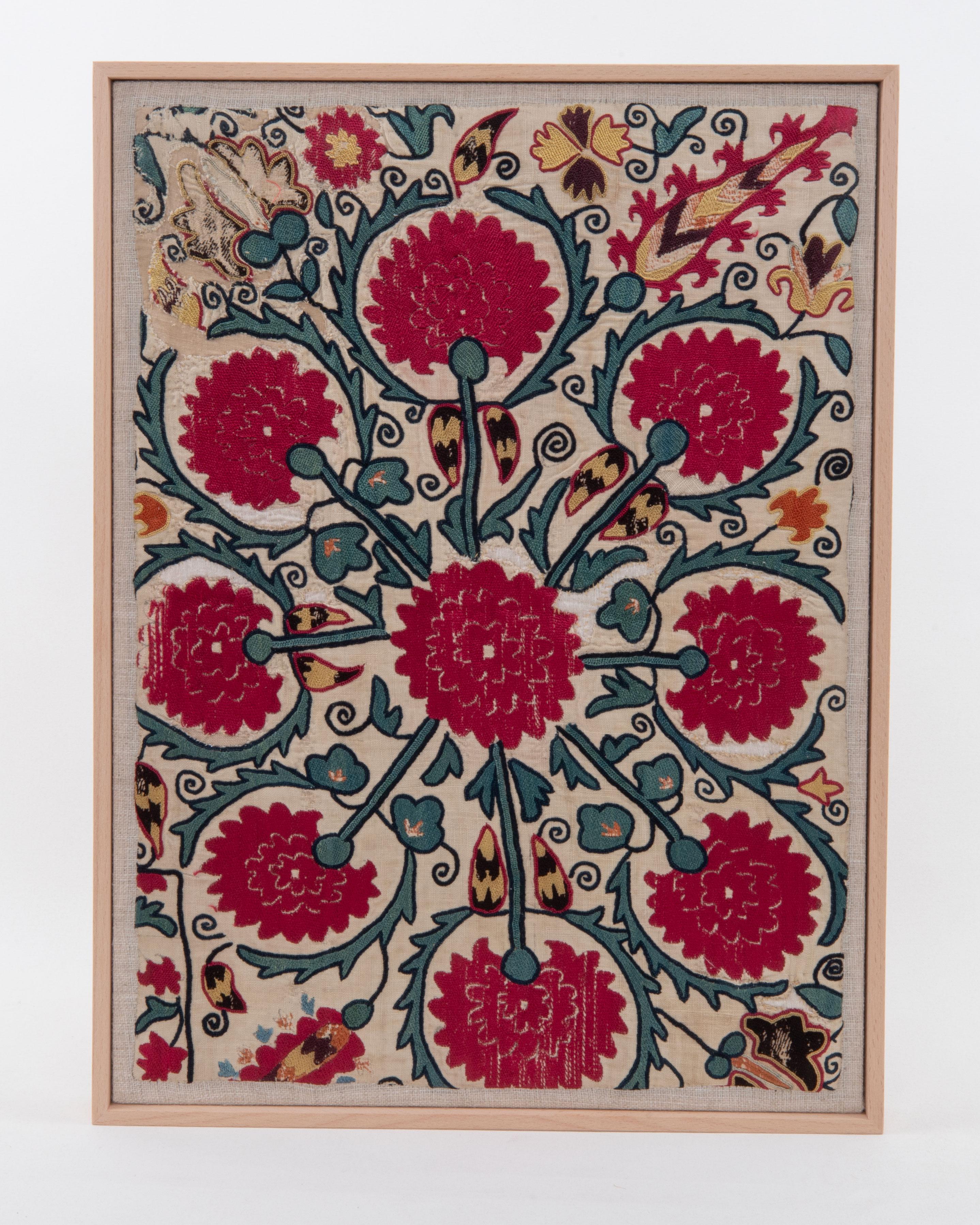 First the fragment has been hand backed on a linen fabric, then stretched over a wooden stretcher and finished with a wooden frame.
Late 19th C. Tajikstan
Ready to go on a wall.

Framed Item above is made from a used and antique embroidery therefore