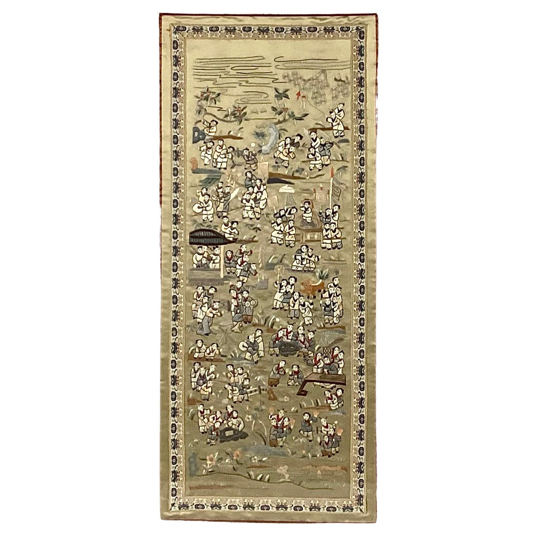 Mid-century Chinese Silk Embroidered Tapestry of Children Playing, which symbolizes innocence and joy.  Tapestry features multiple children in a garden setting surrounded by flowers, foliage, trees and numerous outdoor articles of play such as