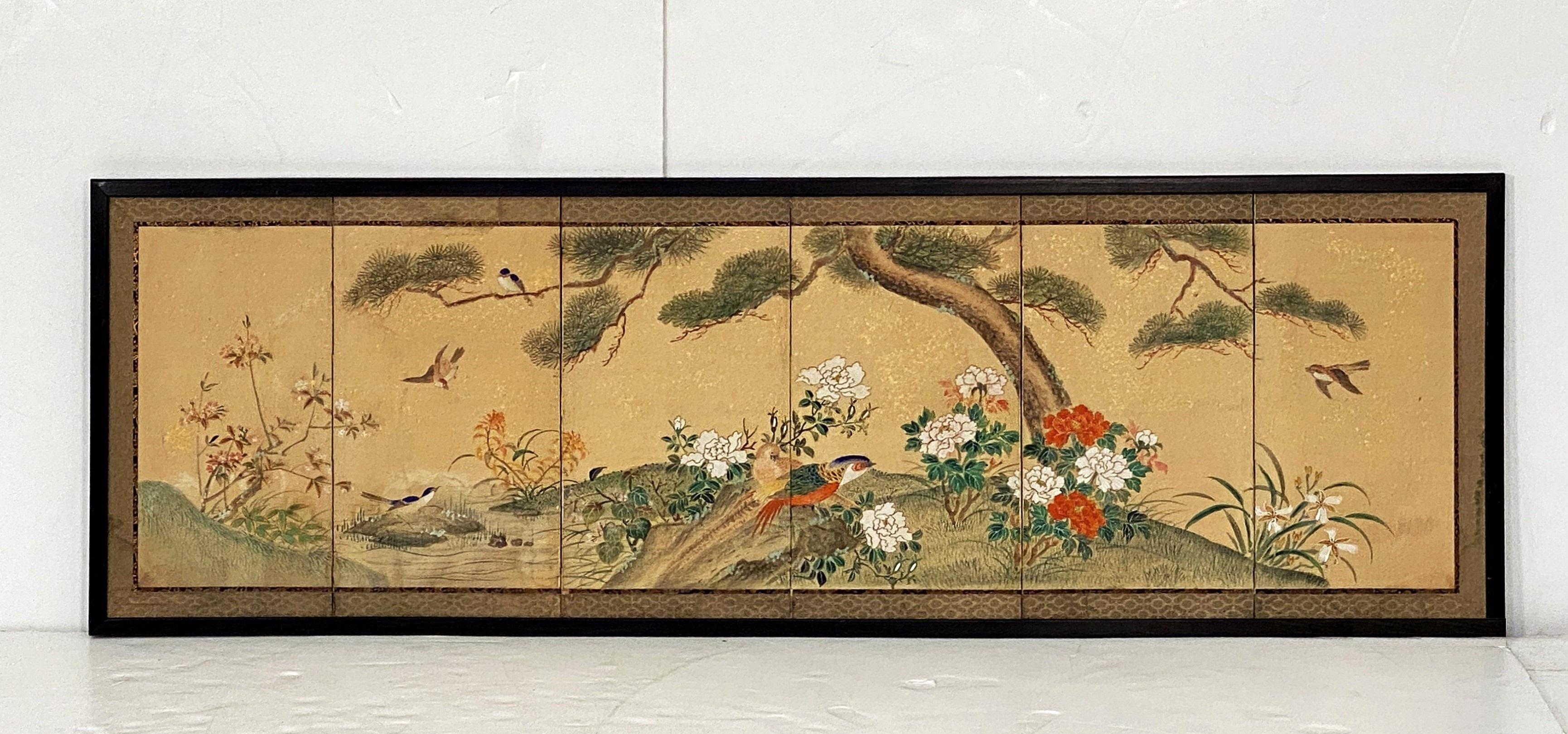 A beautiful framed Chinese six-fold wall-hanging of silk and paper from the 19th Century, featuring a finely hand-painted landscape scene of birds and flowers.
