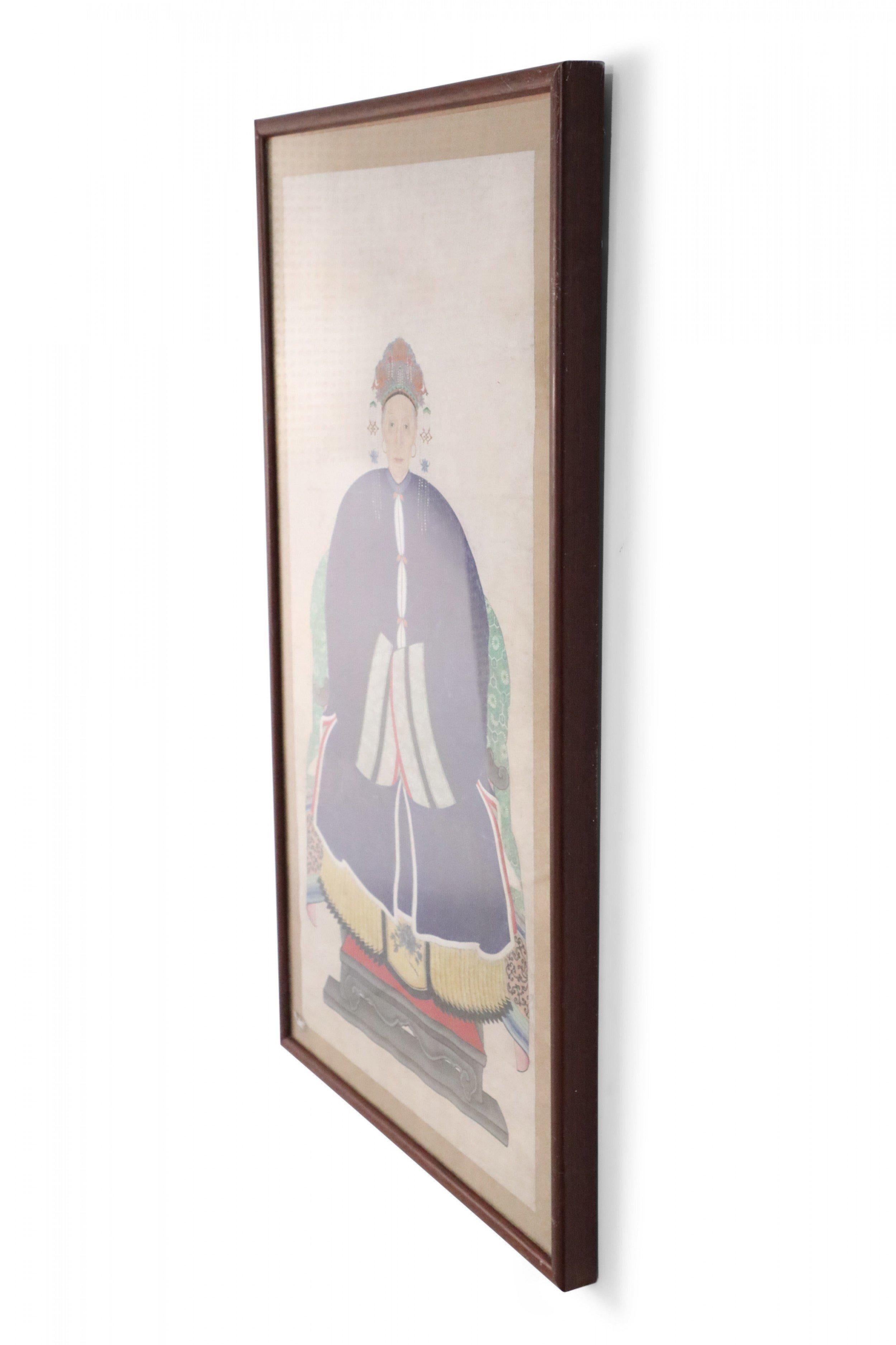 Vintage (20th Century) Chinese pen and ink ancestor portrait capturing the honoree seated in a green chair and wearing an elaborate hat and blue dress, on a beige background with a sage green floral patterned fabric mat, set in a rectangular walnut