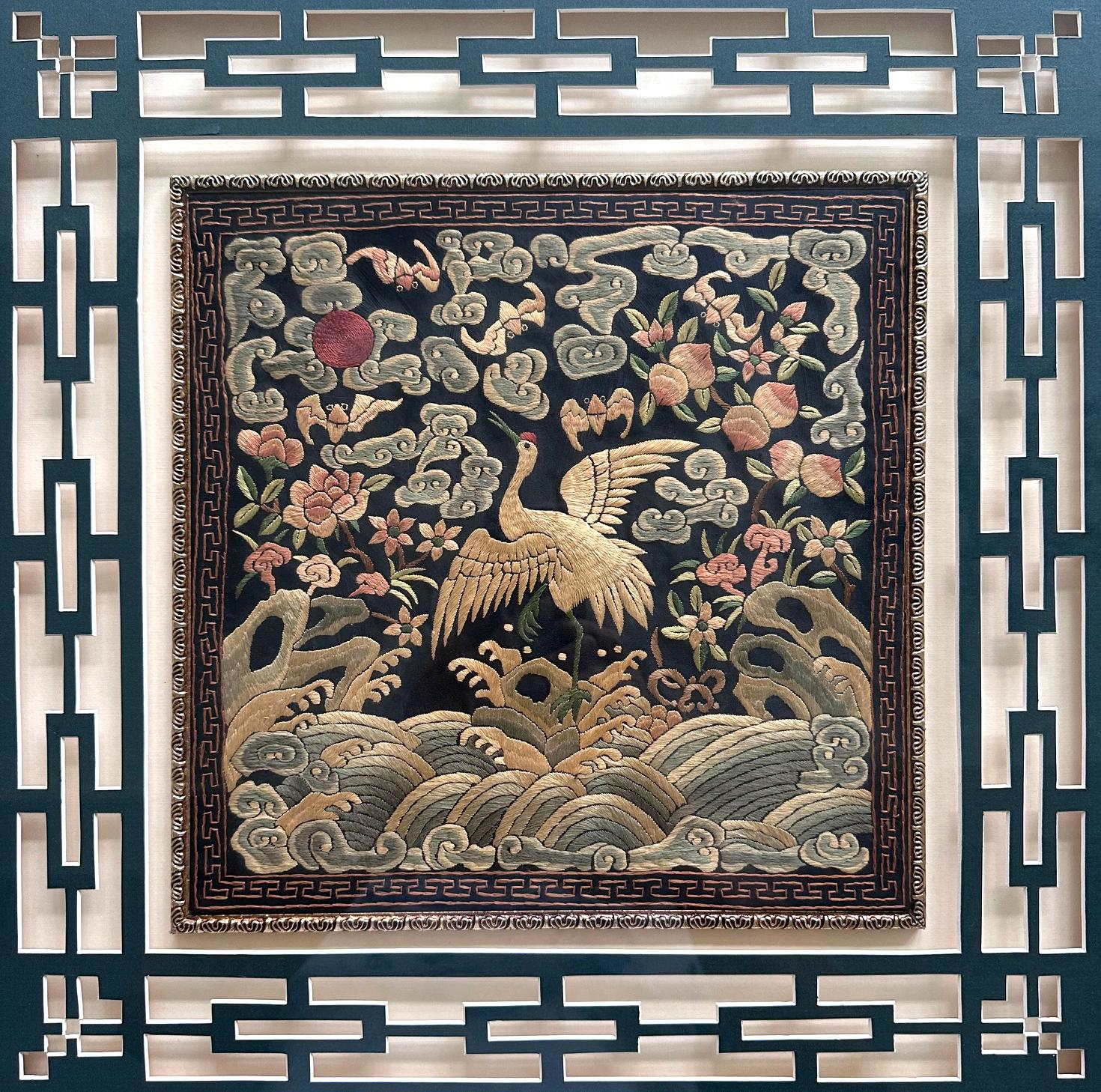 A finely embroidered silk civil rank badge panel presented with elaborate lattice mat and a wood frame circa mid to late 19th century (late Qing dynasty). The square rank badge is known in Chinese as Buzi which was displayed in the front and back of