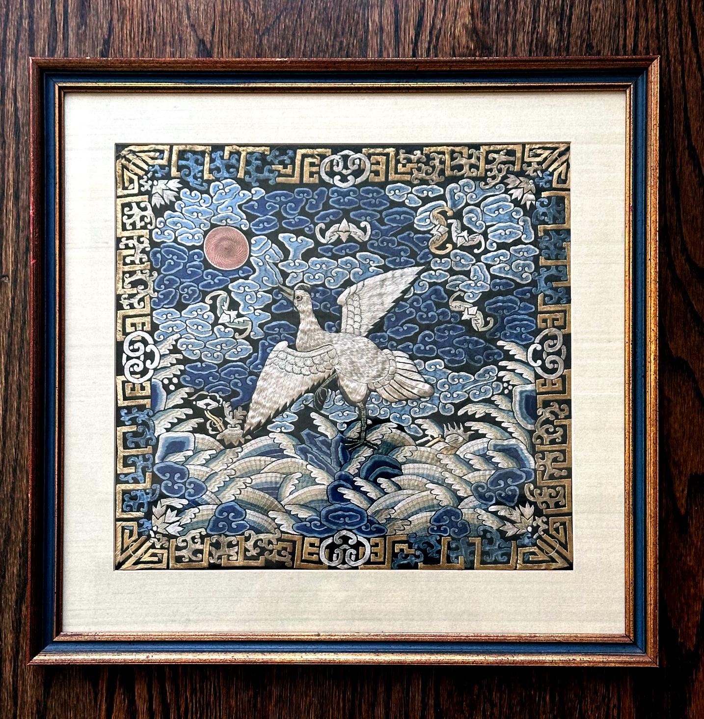 A finely embroidered silk civil rank badge panel framed in a giltwood frame circa 19th century. The square rank badge is known in Chinese as Buzi which was displayed in the front and back of the official robe to indicate one's rank status. The