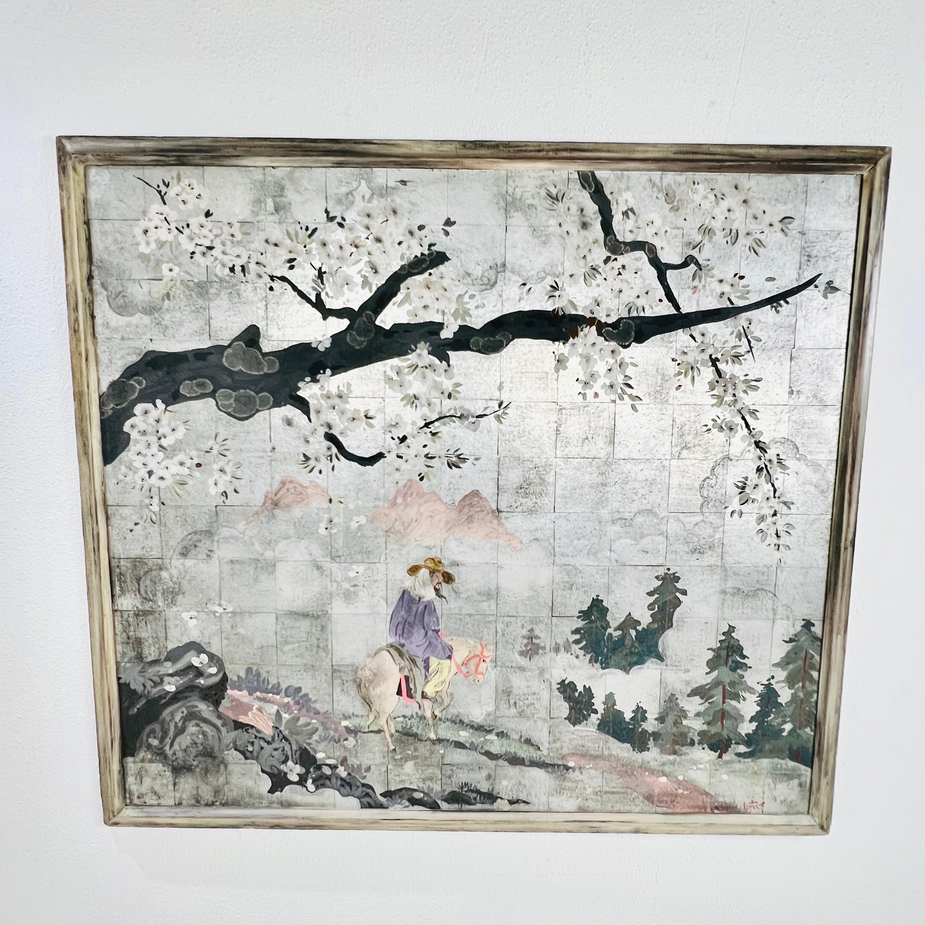 This striking wall panel features a hand-painted chinoiserie scene on a grid of silver leaf tiles. A figure on horseback carrying a lantern rides through a peaceful mountain landscape beneath a flowering tree branch. The soft pastel tones and