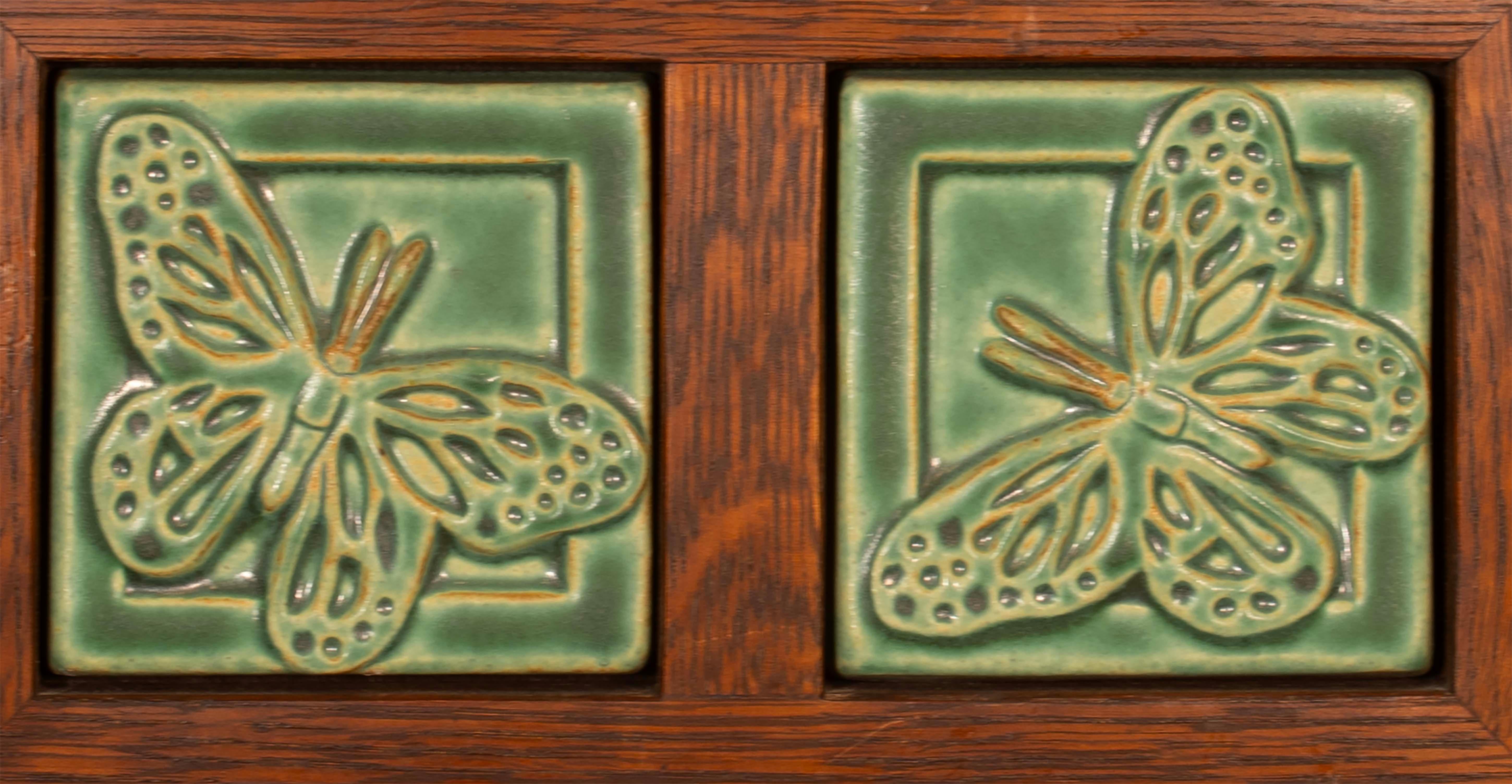 Add a touch of charm to your home with this beautifully crafted framed Pewabic Detroit butterfly tiles. The square tiles feature a stunning green color that will liven up any space. A simple, yet elegant piece that would fit perfectly in any home.