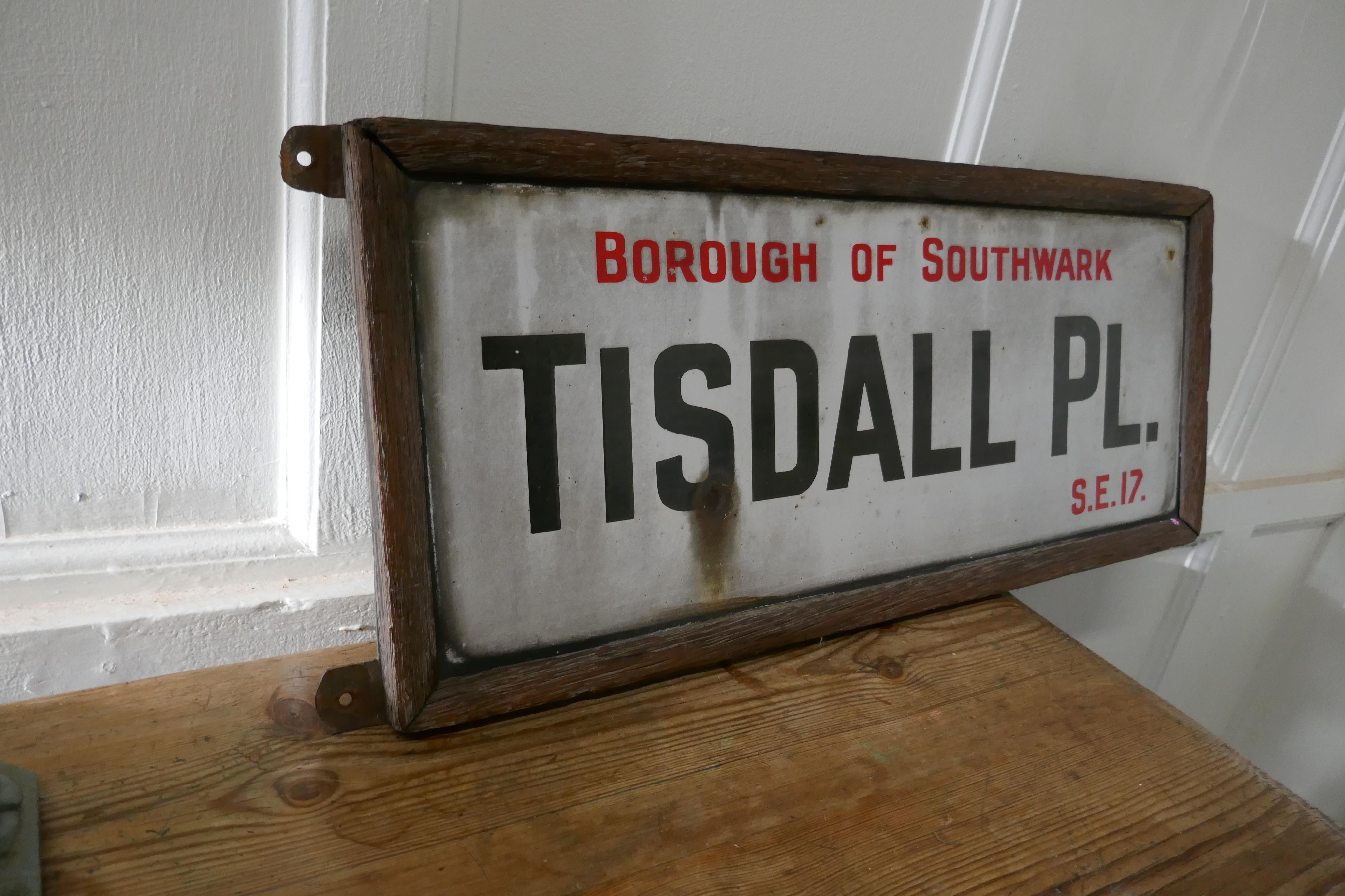 Framed enamel Southwark street sign, Tisdall Place, London

The sign is embossed enamel and is in a very weathered old oak frame with wall fixings
The sign has a little rust but is in generally good condition for its age and all is part of its
