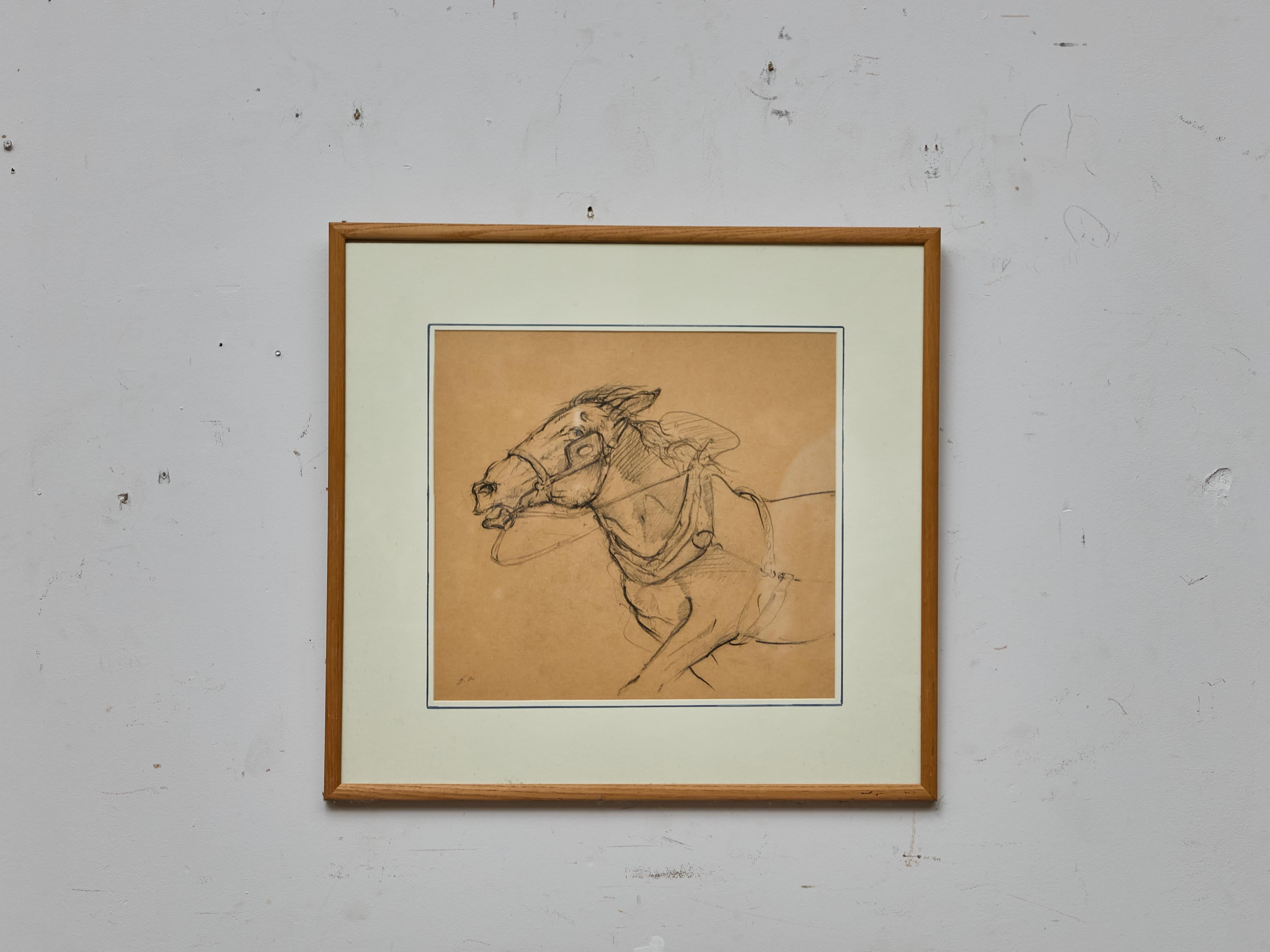 Executed in expressive, confident strokes, this English charcoal drawing captures the head and neck of a galloping horse, its mouth open and bridle taut in motion. Dating to circa 1920, the study conveys a remarkable sense of energy and immediacy,