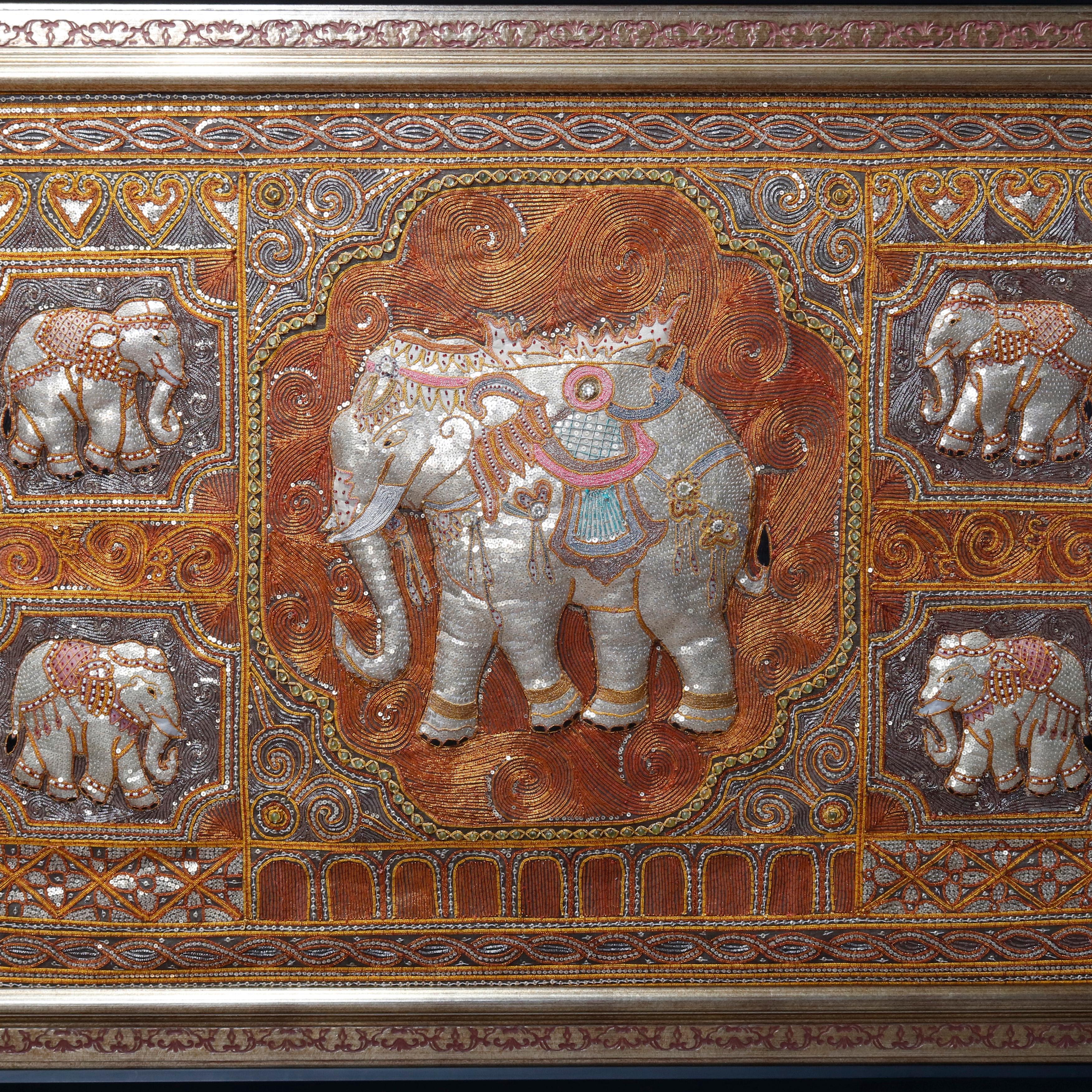 A framed figural Kalaga offers central reserve of an elephant surrounded by additional elephant reserves in a hand embroidered, padded & jeweled tapestry, often associated with Thailand, 20th century

***DELIVERY NOTICE – Due to COVID-19 we are