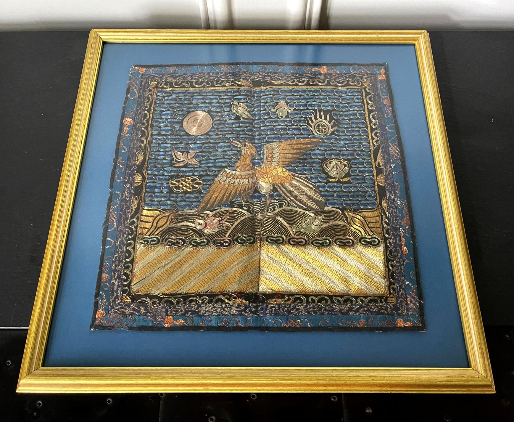 A finely embroidered silk civil rank badge panel presented in a giltwood frame circa mid-late 19th century. The square rank badge is known in Chinese as Buzi. The design is centered by a golden peasant, the symbol of the second rank official in the