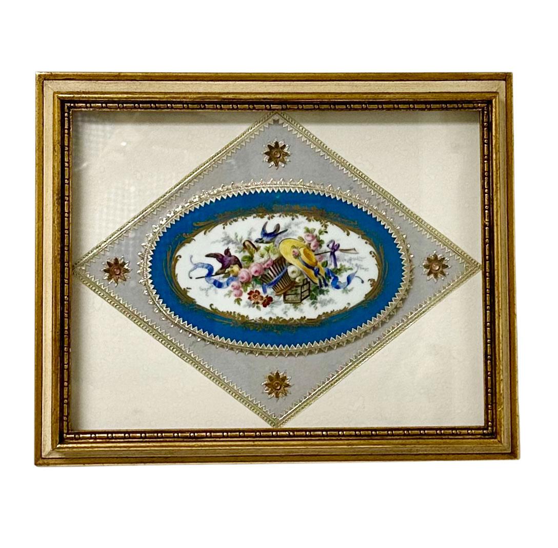 A piece, fragment of porcelain off of a piece of furniture in a shadowbox and trimmed in French braided ribbon in the neoclassical style. Early 19th century porcelain could be a little older. The paper label shows where it was bought in New York