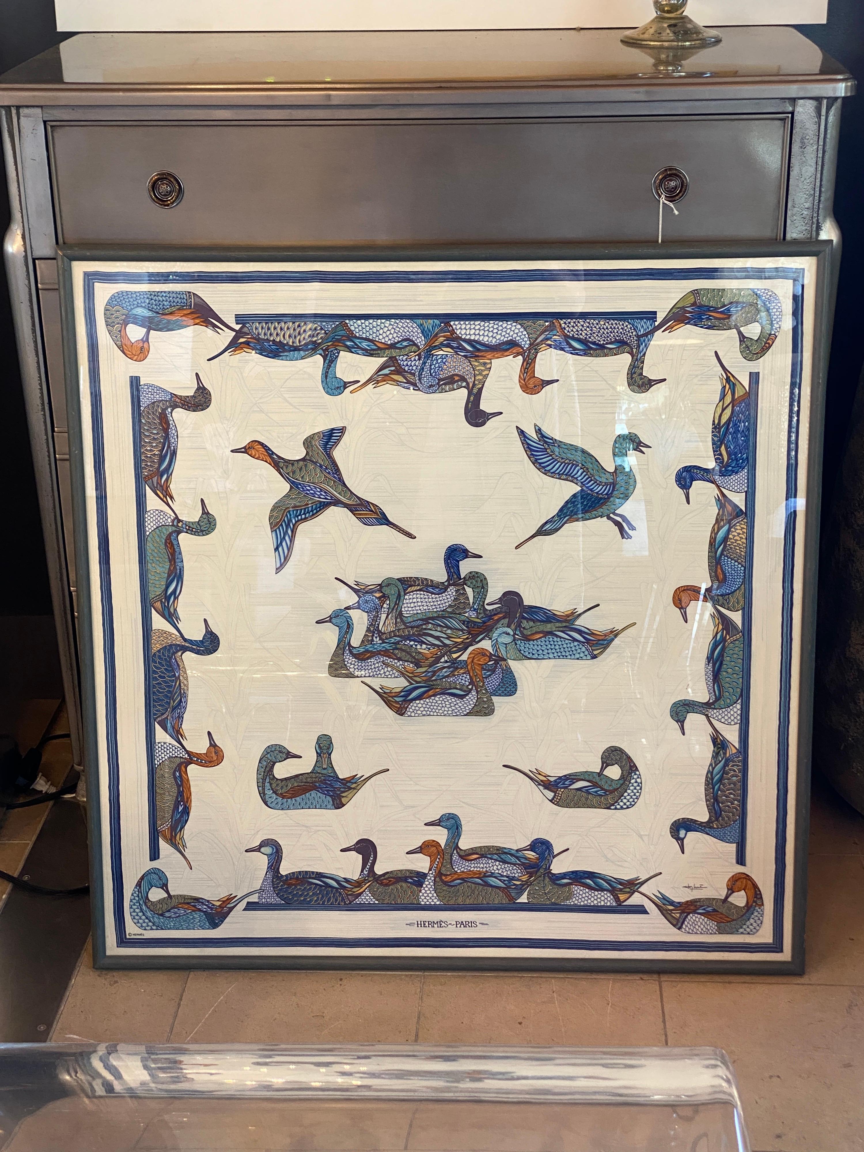 Framed Hermes scarf La Mare Aux Canard 

Beautiful Blues, Greens and Amber tones on scarf, with a blue/green Frame.