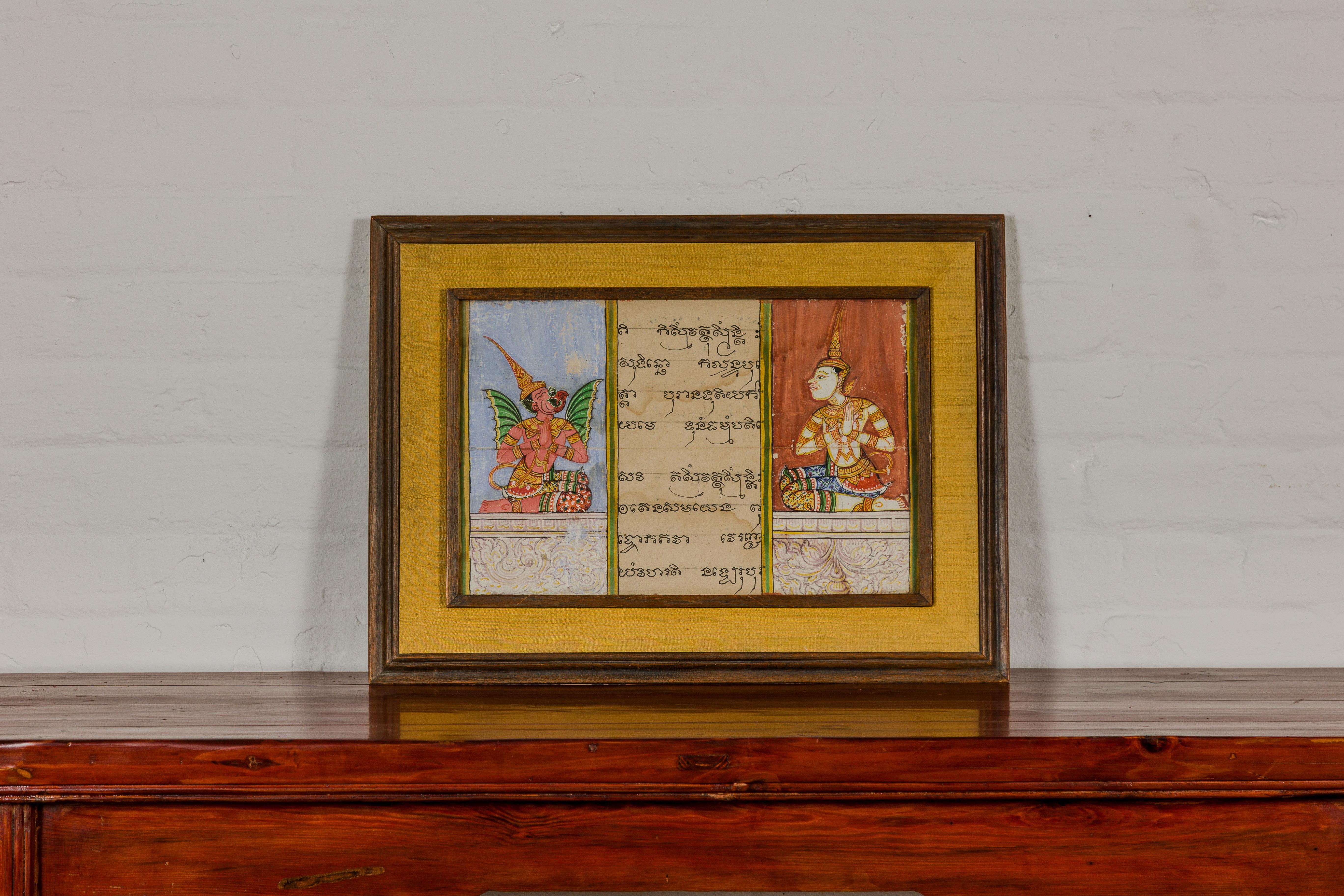 A vintage illuminated page manuscript taken from a Thai Buddhist prayer book and set inside custom wooden frame under glass. This vintage illuminated manuscript page, delicately extracted from a Thai Buddhist prayer book, is a captivating piece of