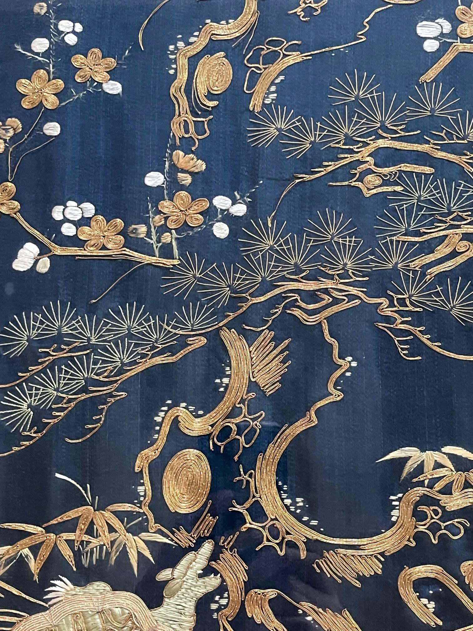 A Japanese Fukusa Panel displayed in a wood frame circa late 19th century Meiji Period. Fukusa is a traditional Japanese textile art used as a wrap for presenting gifts at important occasions. On the deep blue background, the elaborate embroidery