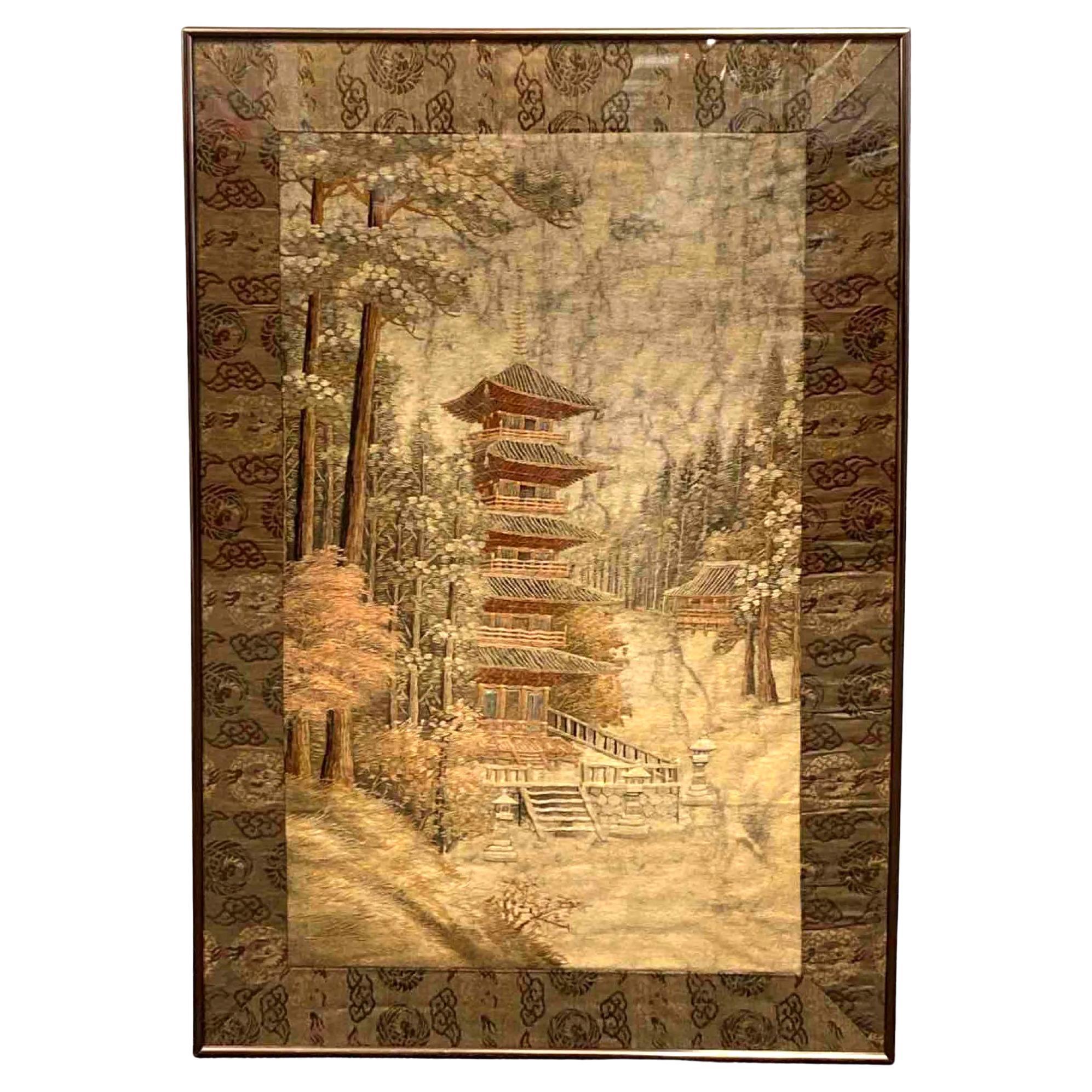 A Japanese silk embroidery landscape scenery panel depicting a Buddhist pagoda and a temple compound set in a forest with towering pines and red maple trees. This type of pictorial panels was made mostly in the early 20th century (1910-20s) toward
