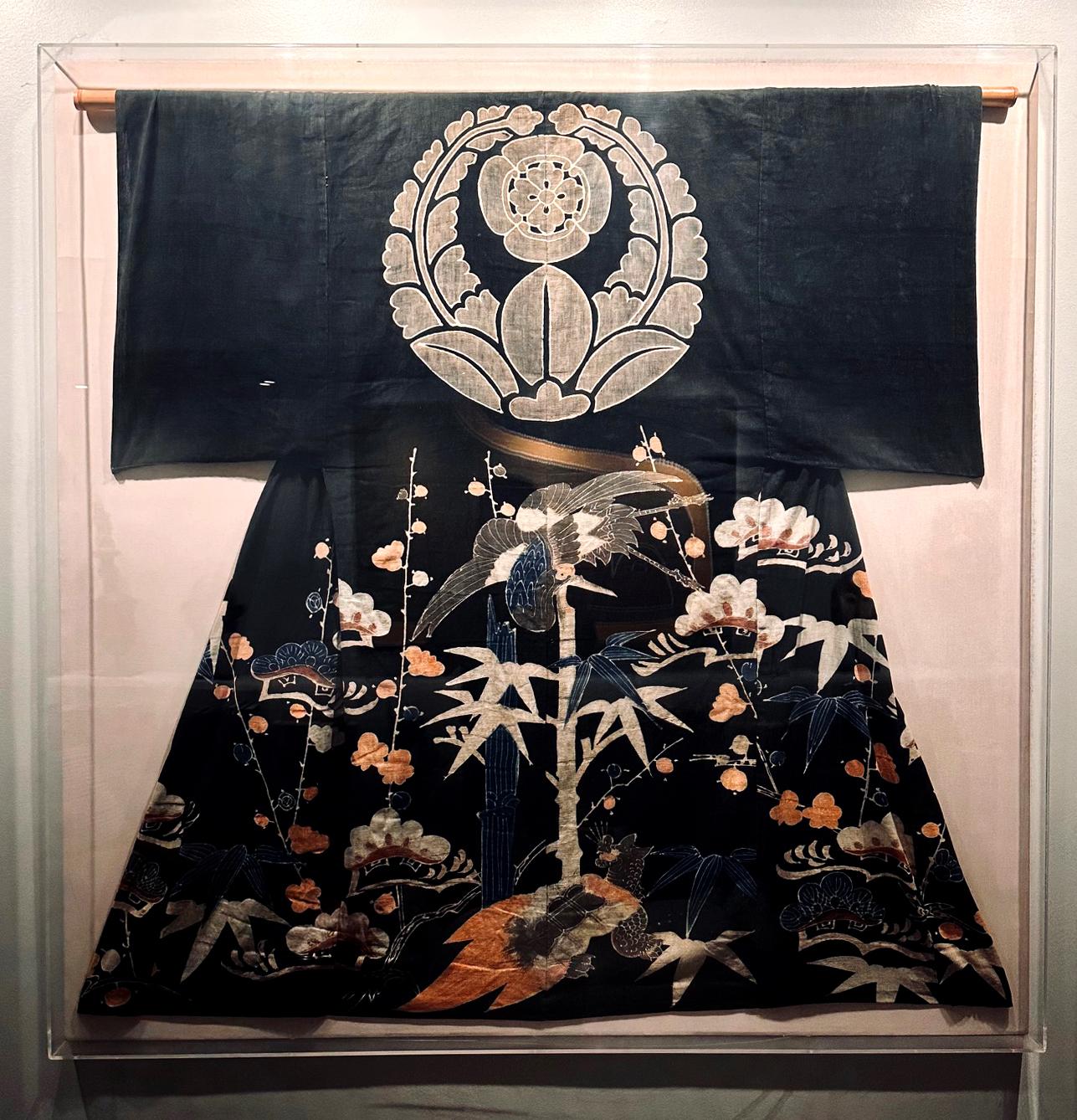 A Japanese festival kimono expertly mounted and displayed in a large acrylic shadow box. This impressive ceremonial garment circa late 19th-early 20th century was made from a thick linen or linen/cotton blend and splendidly decorated with resistant