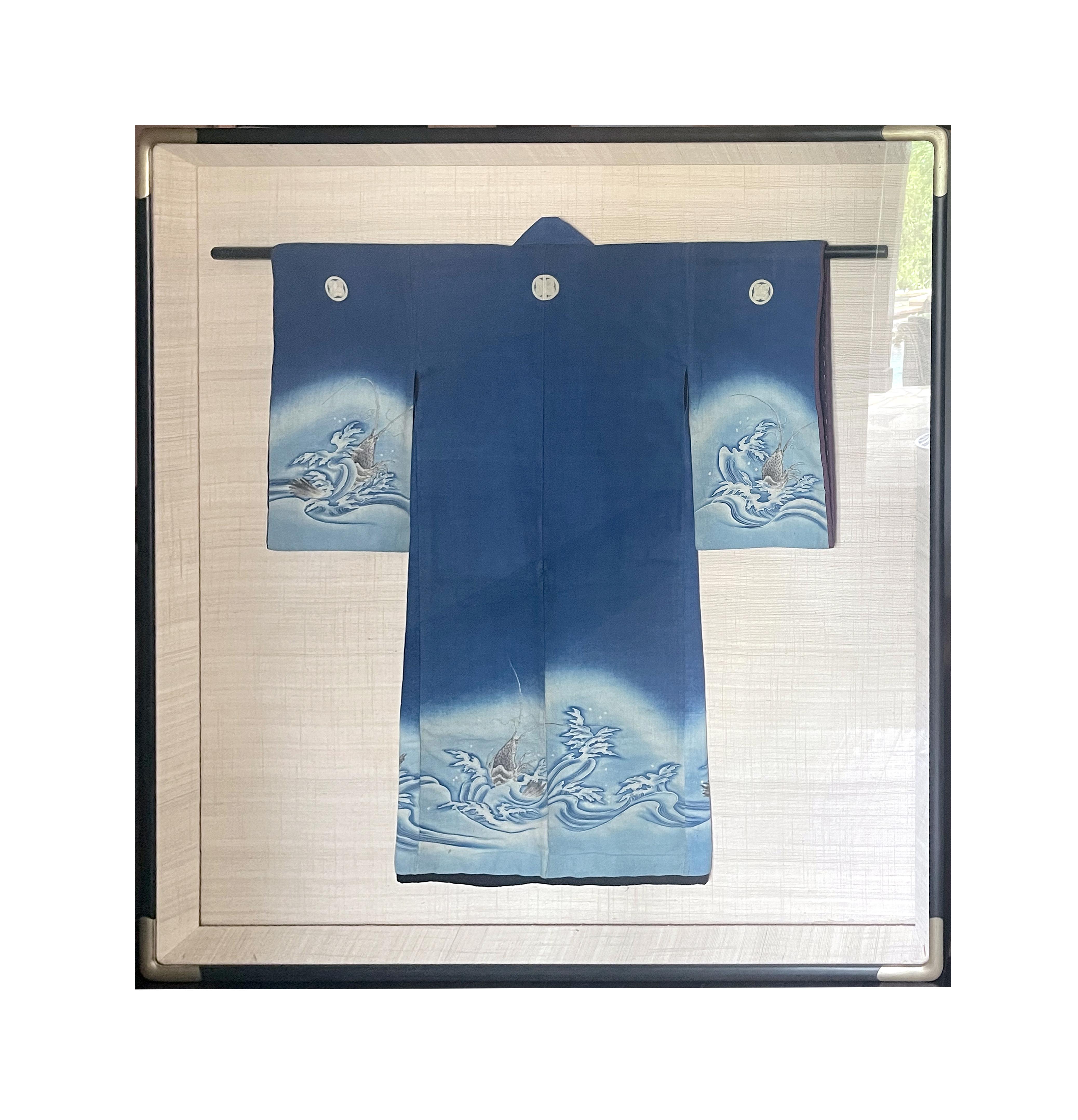 A Japanese Fisherman's Festival Kimono circa late 19th to early 20th century Meiji period. Made from indigo dyed cotton with thin inner padding and lining, the kimono appears to fit a teen boy due to its size. The lower part of the main body