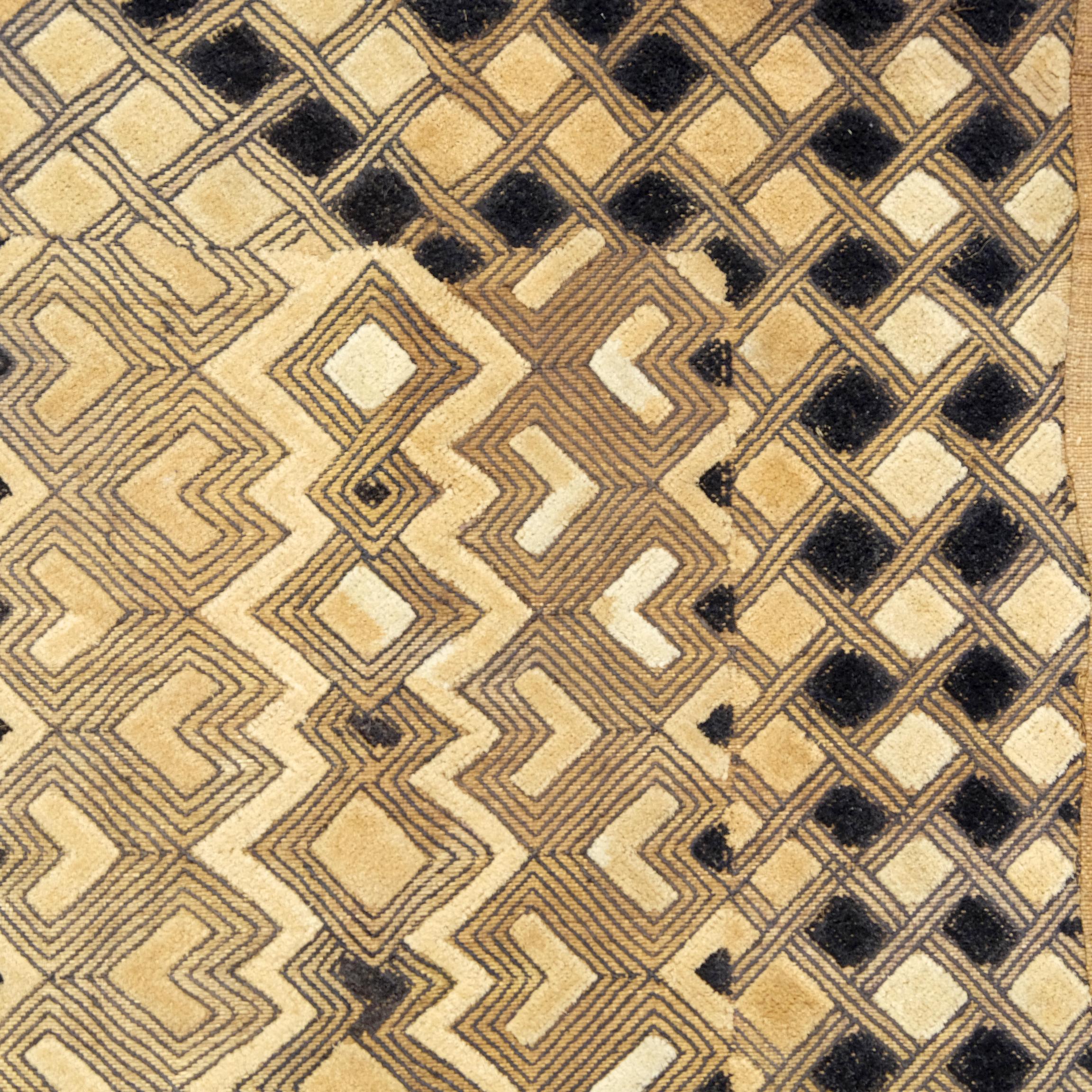 A vintage Kuba cloth in plain black timber frame. 
Kuba textiles are unique to the Democratic Republic of Congo and are prized for their complexity of design and earthy tones. Traditionally in Kuba society, the men weave the raffia cloth and the