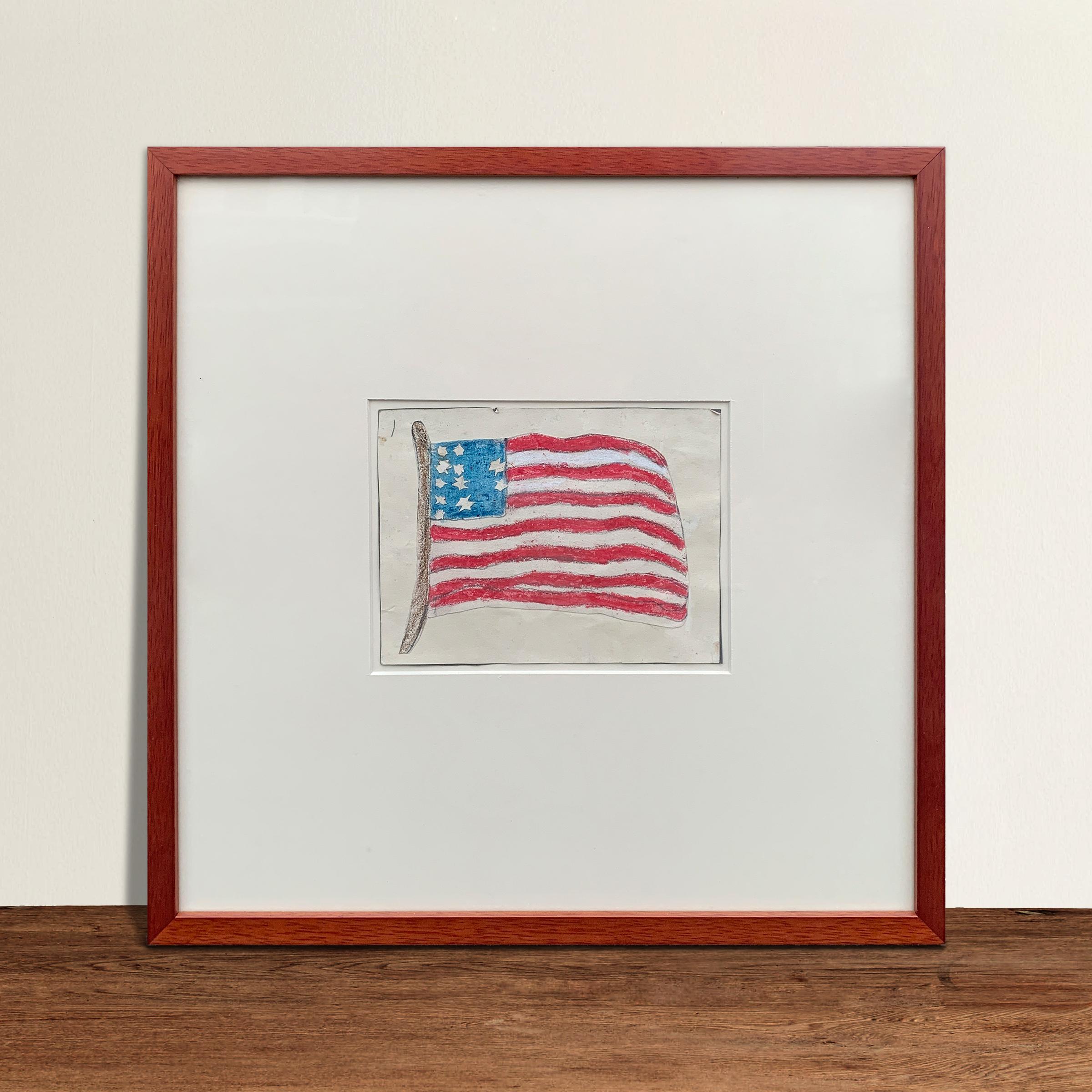 A wonderfully whimsical and delightful 20th century American flag collage composed with a red, white, and blue flag colored with crayon on paper, cut out and applied to more paper. The stars are cut out of paper and applied to the flag. Floated,