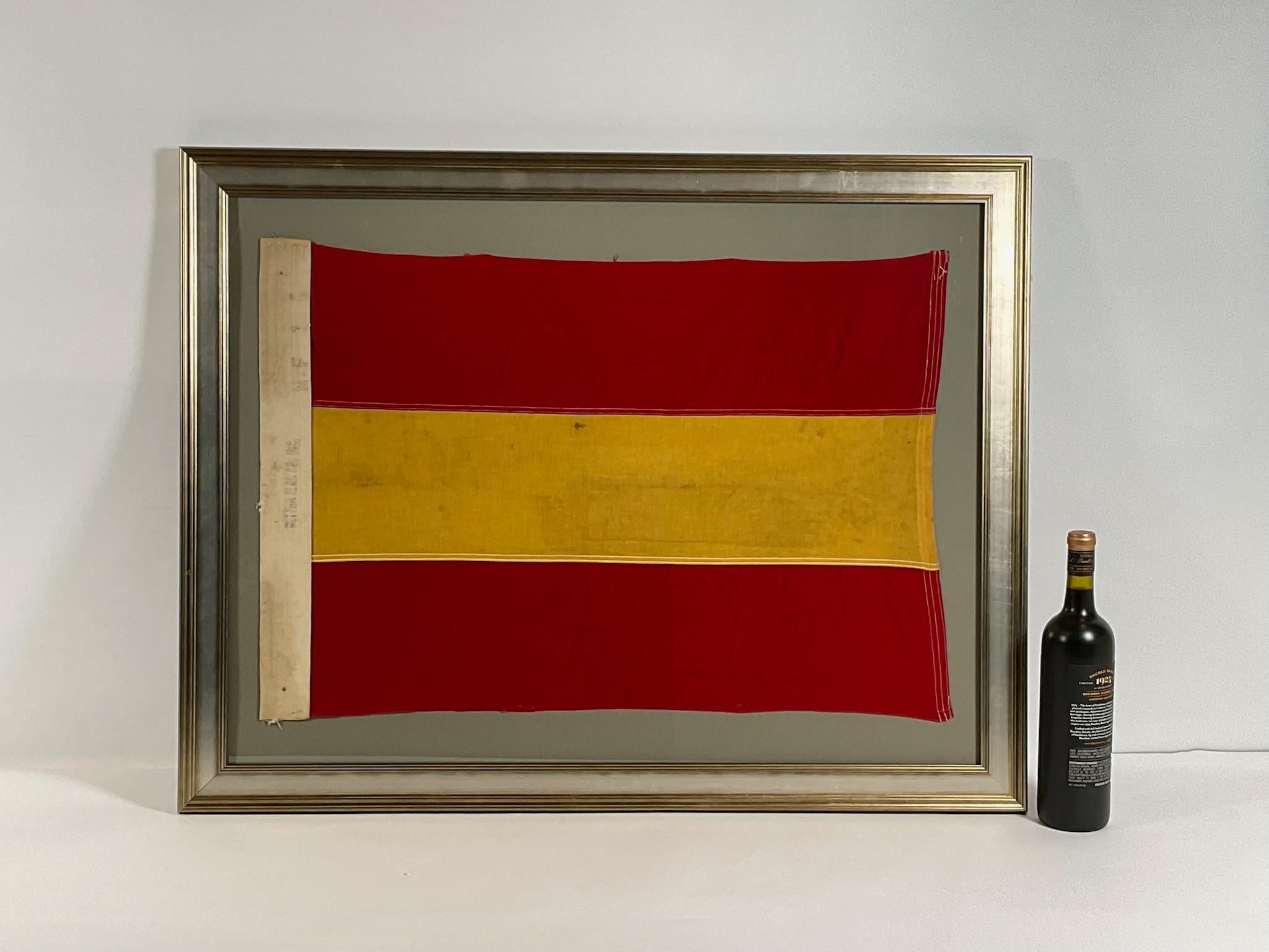 Linen maritime flag with sturdy canvas hoist and stitched panels of yellow and red. The hoist is stamped Dettra Flag Company Incorporated. This is a US Navy signal for number ONE, signal code