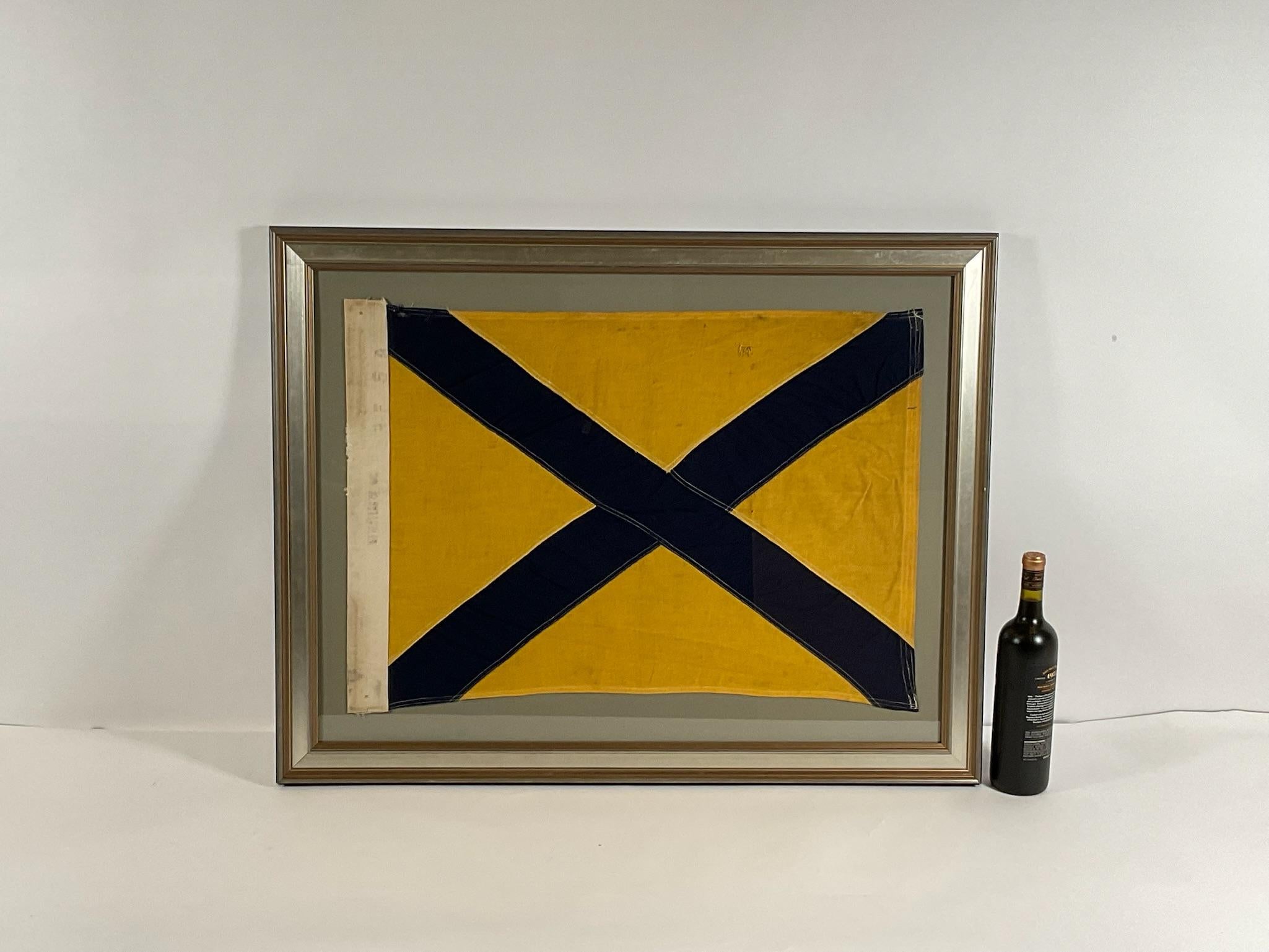 Linen maritime flag with sturdy canvas hoist and stitched panels of yellow and blue. The hoist is stamped Dettra Flag Company Incorporated. This is a US Navy signal for number FIVE, signal code 