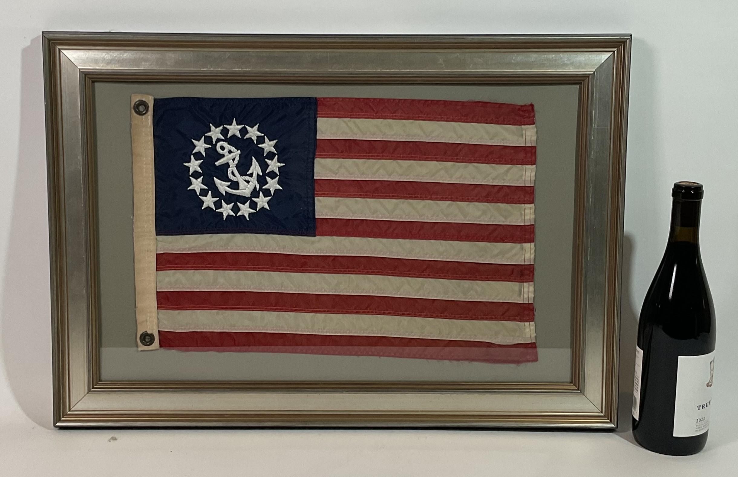 Framed yacht ensign flag with embroidered fouled anchor surrounded by stars in the blue field. This panel identifies a vessel as a pleasure craft, not a commercial vessel.

Weight:    6 lbs.
Overall Dimensions:    18