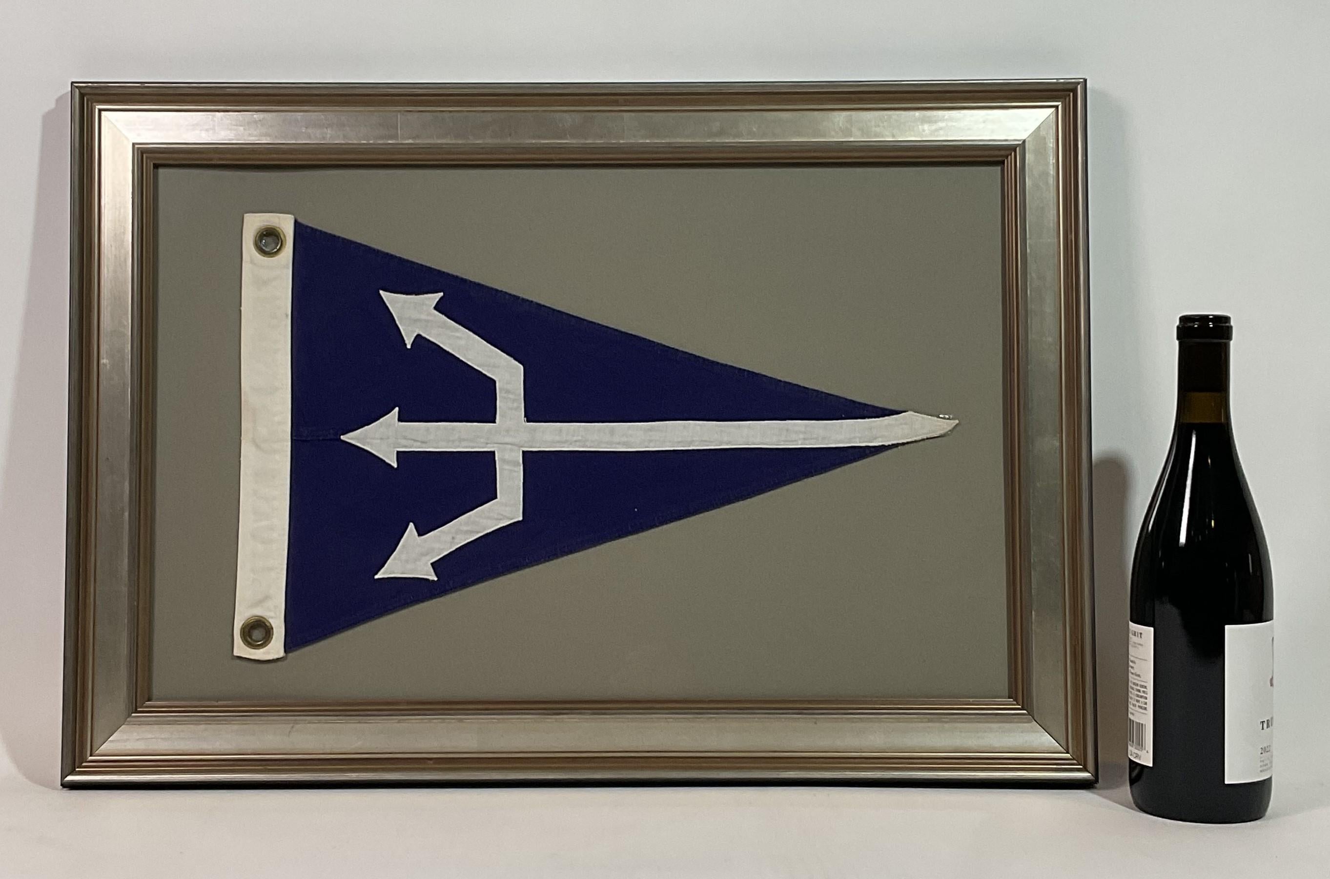 Linen flag with a large white trident spear stitched onto a blue field, white hoist with brass grommets. Set into a frame with gray matting.

Weight:    6 lbs.
Overall Dimensions:    18