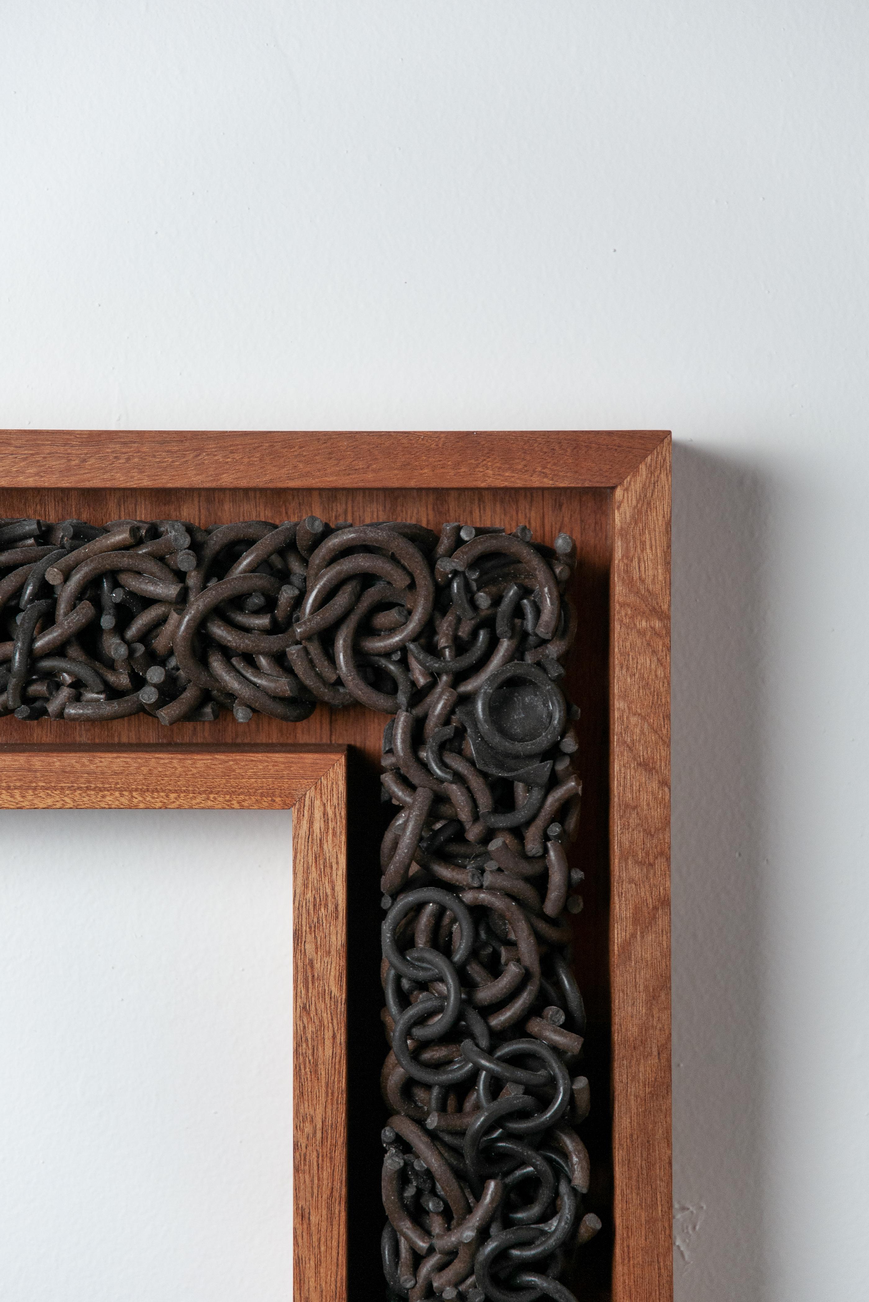 This wall sculpture balances the strength and delicacy of its materiality through the texture of the broken and whole ceramic links. These works are assembled from the collected ruins of previous work--they hold the history of the artists making