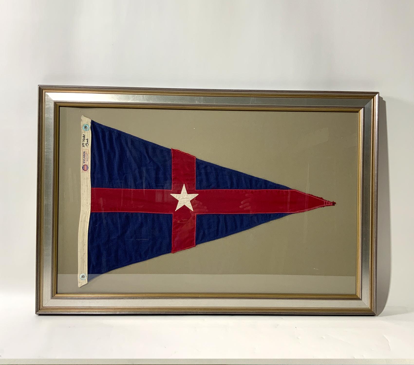 Vintage framed New York Yacht Club Burgee. Flag is a red field with crossed blue stripes and white star. The N.Y.Y.C. has clubhouses in Bew York and Newport. Flag is by Annin of New York, makers of the flag from every America's Cup Yacht since 1851.