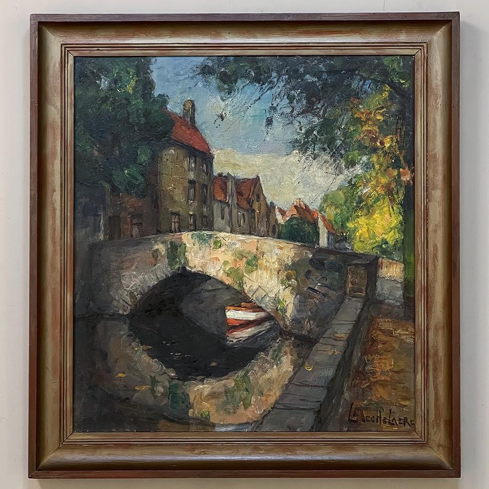 Framed oil painting on canvas of bruges by Leo Mechelaere (1880-1964) is a charming depiction of the storied city of Bruges, centuries ago a bustling port eventually eclipsed by Antwerp, and connected to other surrounding villages and cities with a
