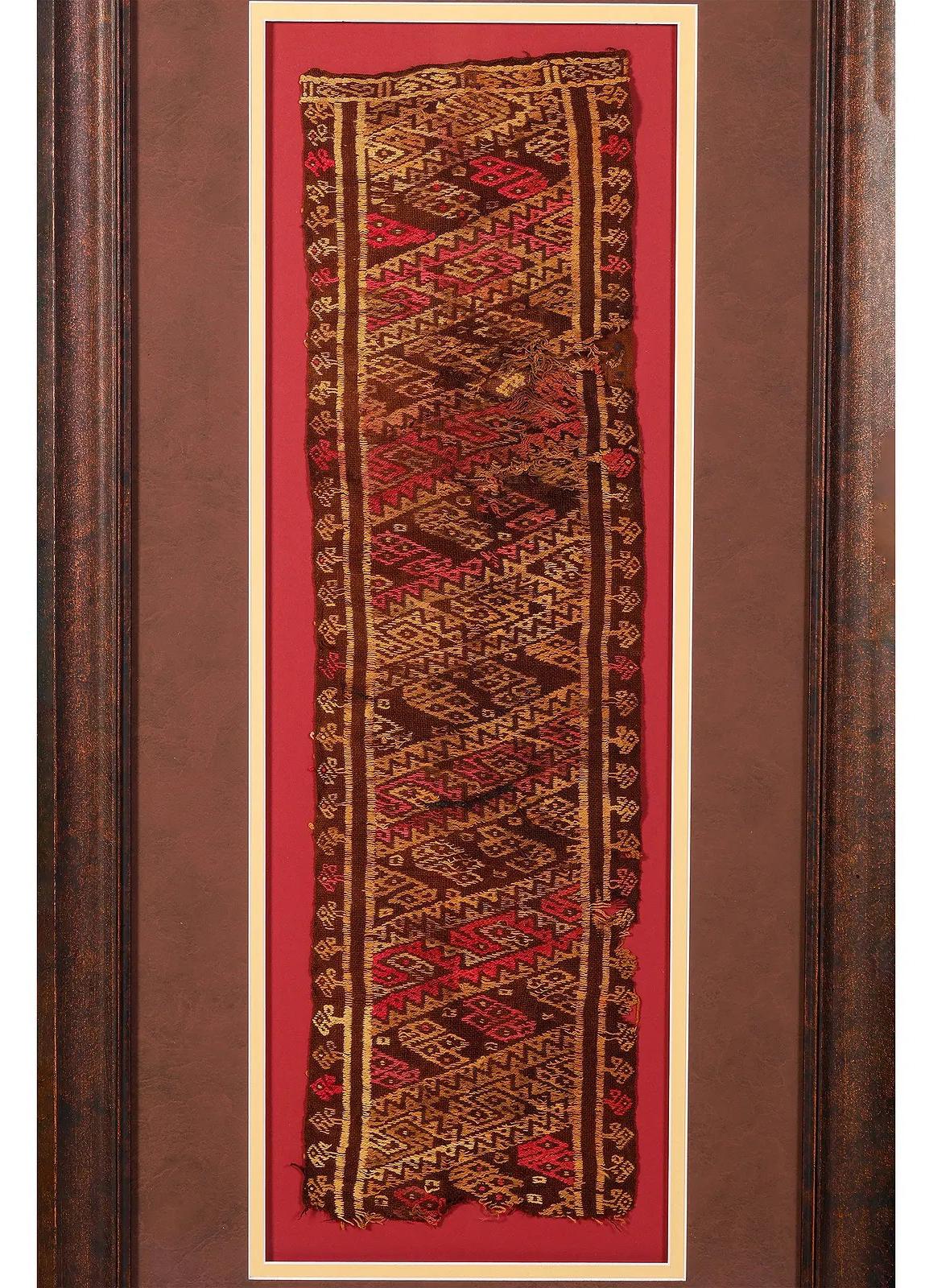 A fragment of antique pre-Columbia textile panel from Chimu or Chancay culture located in Central and Northern Coast of nowadays Peru. Chancay culture thrived in the late Intermediate period/ late Horizon circa 1000-1470 CE until it was incorporated