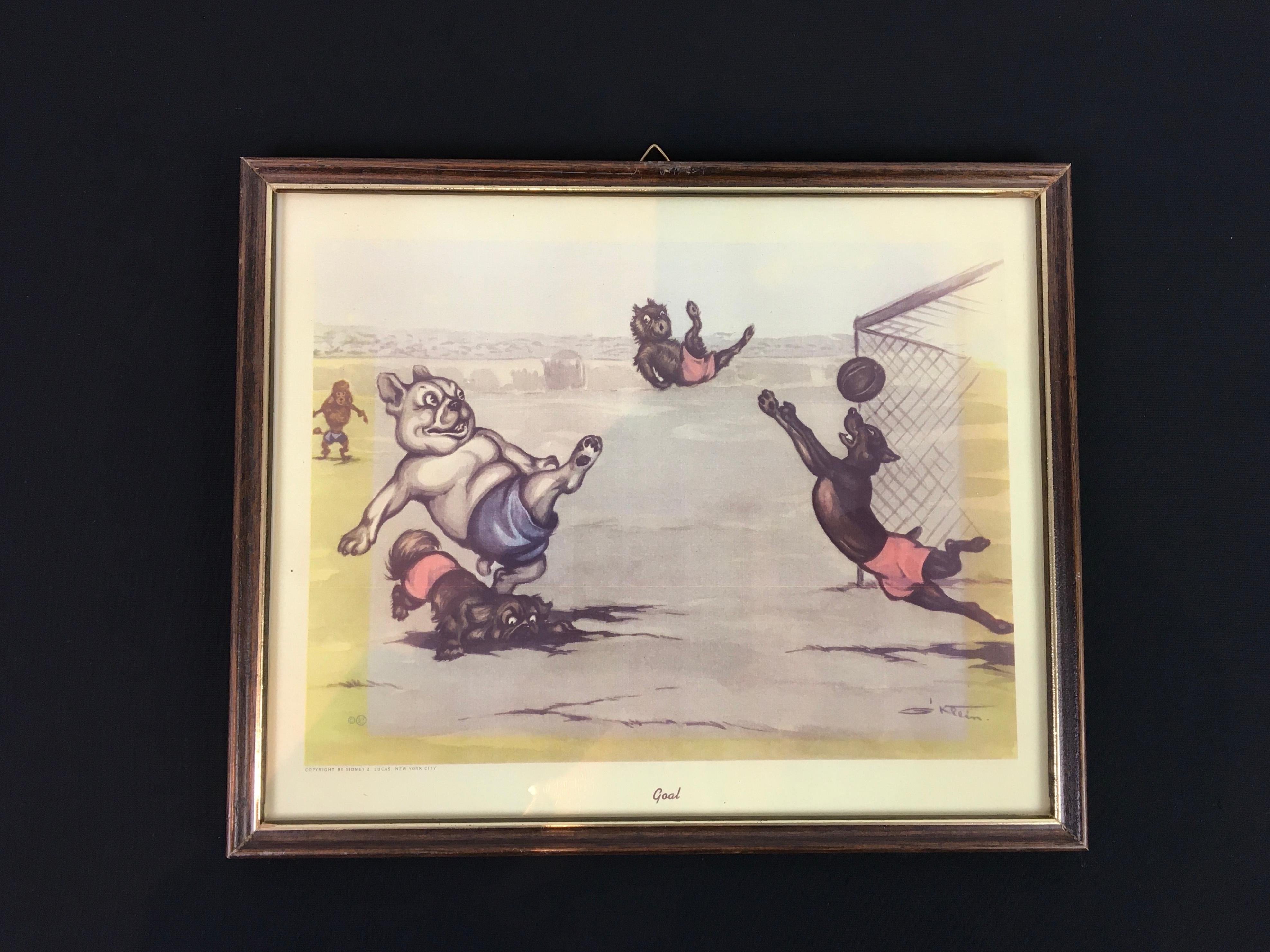 Framed print of dogs playing football and making a goal. 
Ilustrated by Boris O' Klein. 
Boris O' Klein was A French artist and cartoonist. 
Also known as an anthropomorphic artist, known for his numerous prints and watercolors of dogs getting up