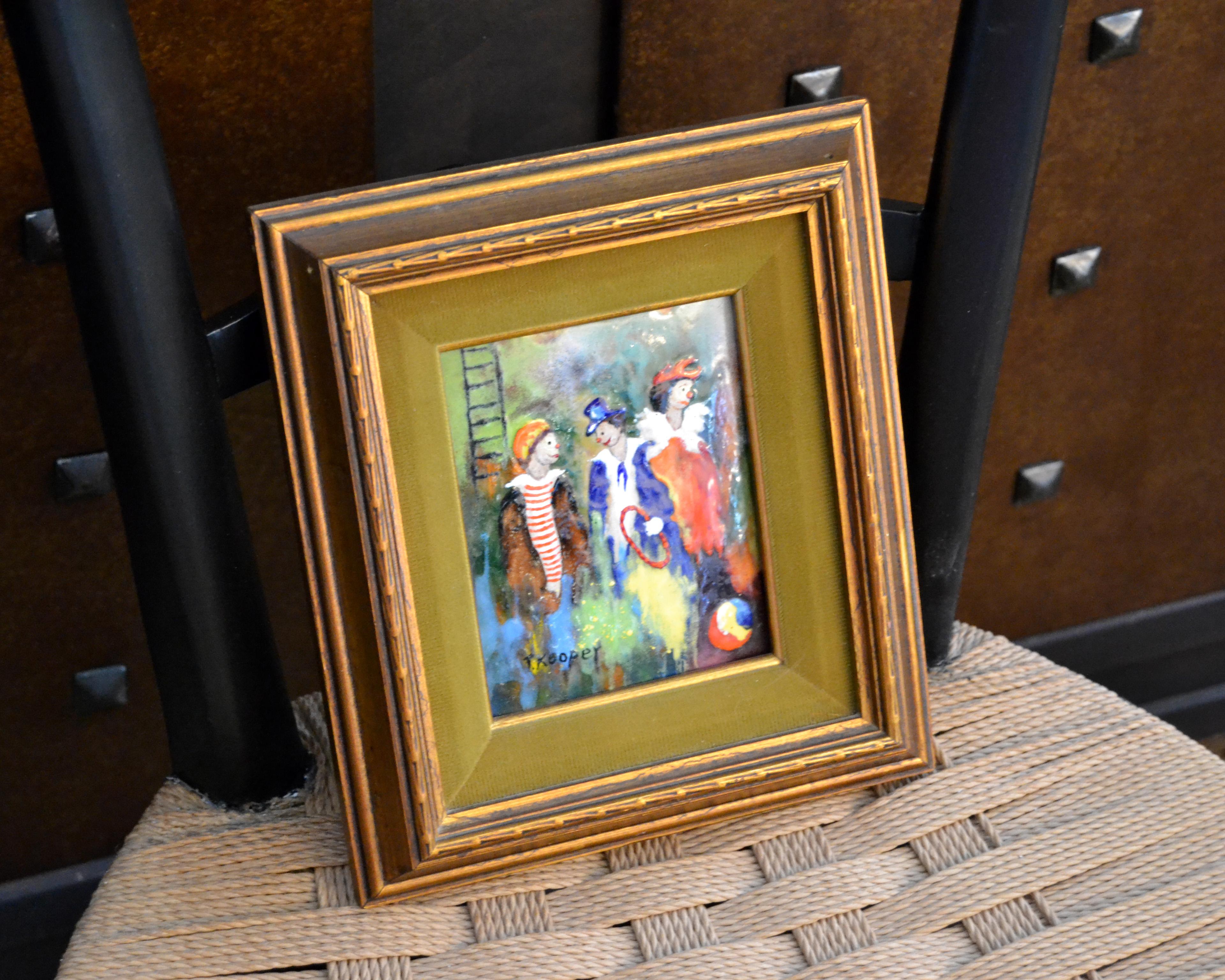 Framed colorful realism enamel painting on copper by T. Kooper Three Circus Clowns. 
Signed by Artist and numbered 25 on reverse.