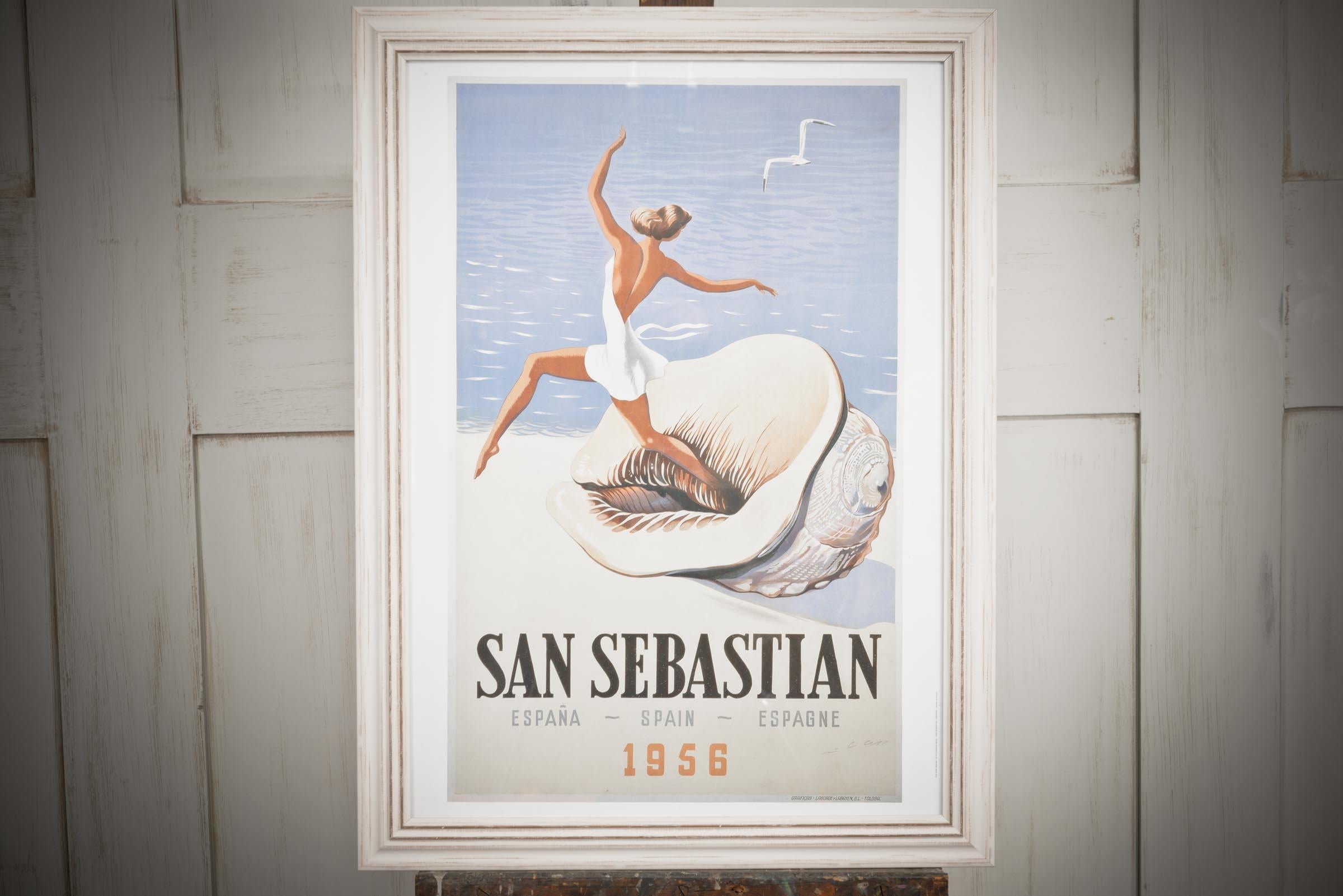 Superbe affiche encadrée datant de 1956 à San Sebastian en Espagne - Une élégante dame dansant sur un coquillage surdimensionné sur les rivages sablonneux de San Sebastian. Ce poster ajouterait de la classe et de l'élégance à n'importe quelle pièce