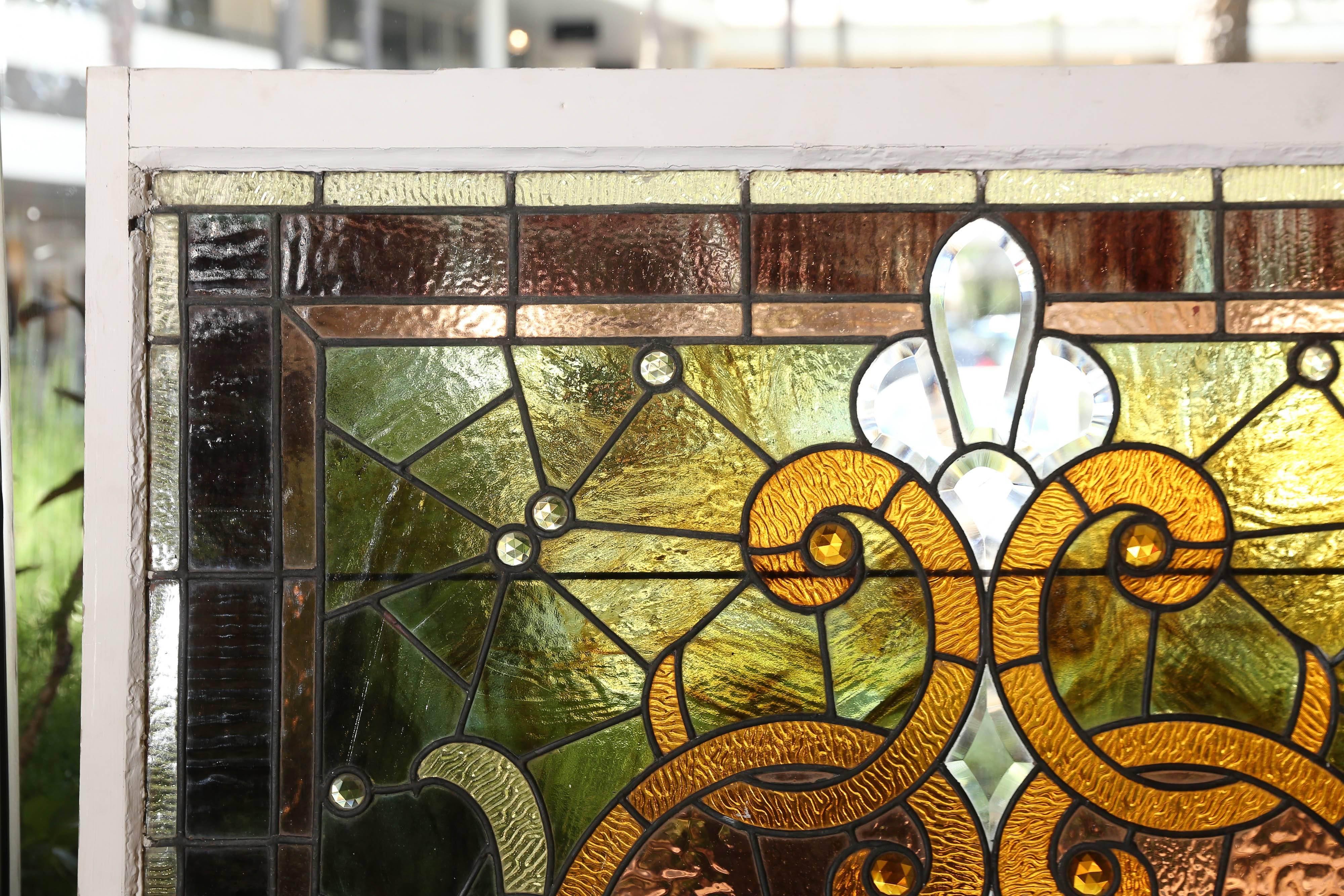 Large and beautiful framed glass panel in gold, green and
Bronze hues. The glass is in fine condition.
 