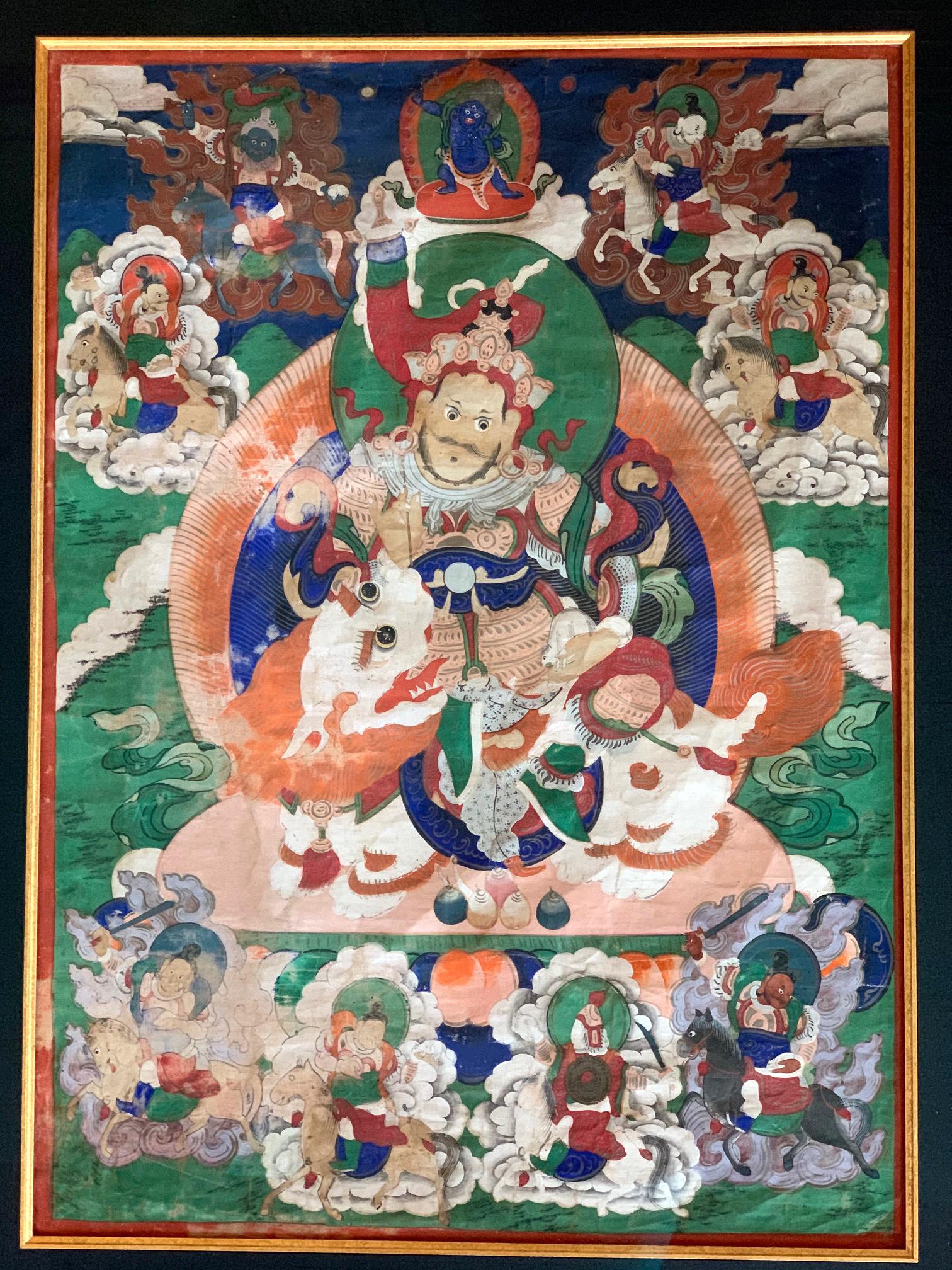 Framed Tibetan painted thangka likely dated to 19th century. The piece depicts a central Lokapala named Vaisravana, one of the four Heavenly Kings. In Tibetan Buddhism, he is also known as Jambhala, or 