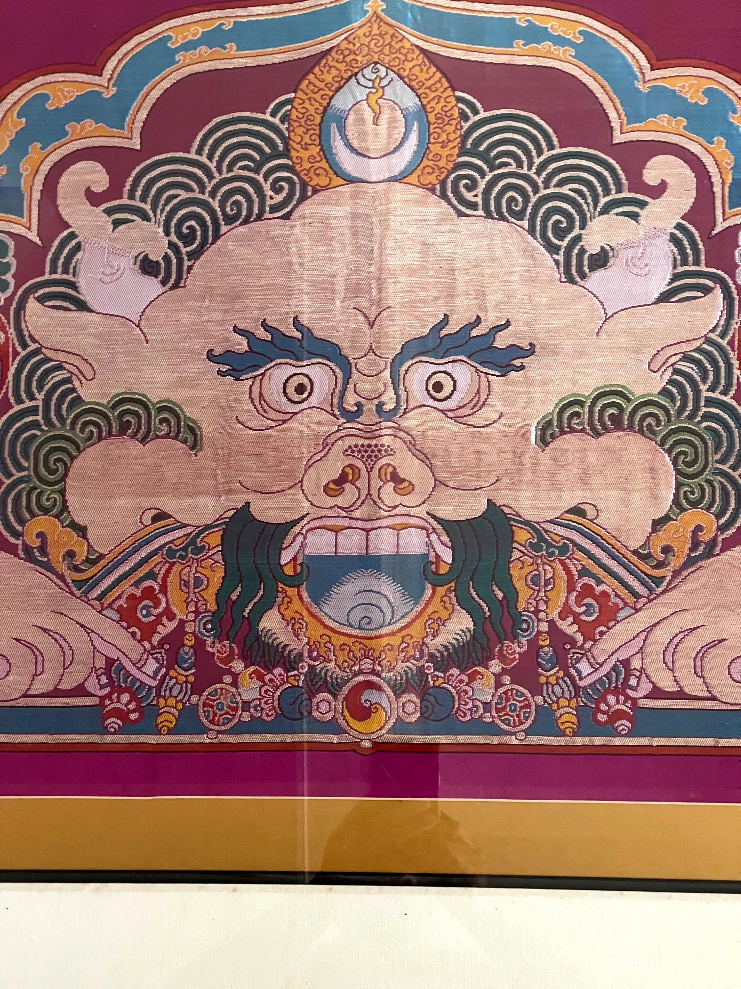 A woven silk Kesi panel depicts Kirtimukha from Tibet circa the second half of 20th century. Beautifully woven from short weft silk with superb coloring and delineation details, the bright colored panel was likely used as a curtain or banner for a