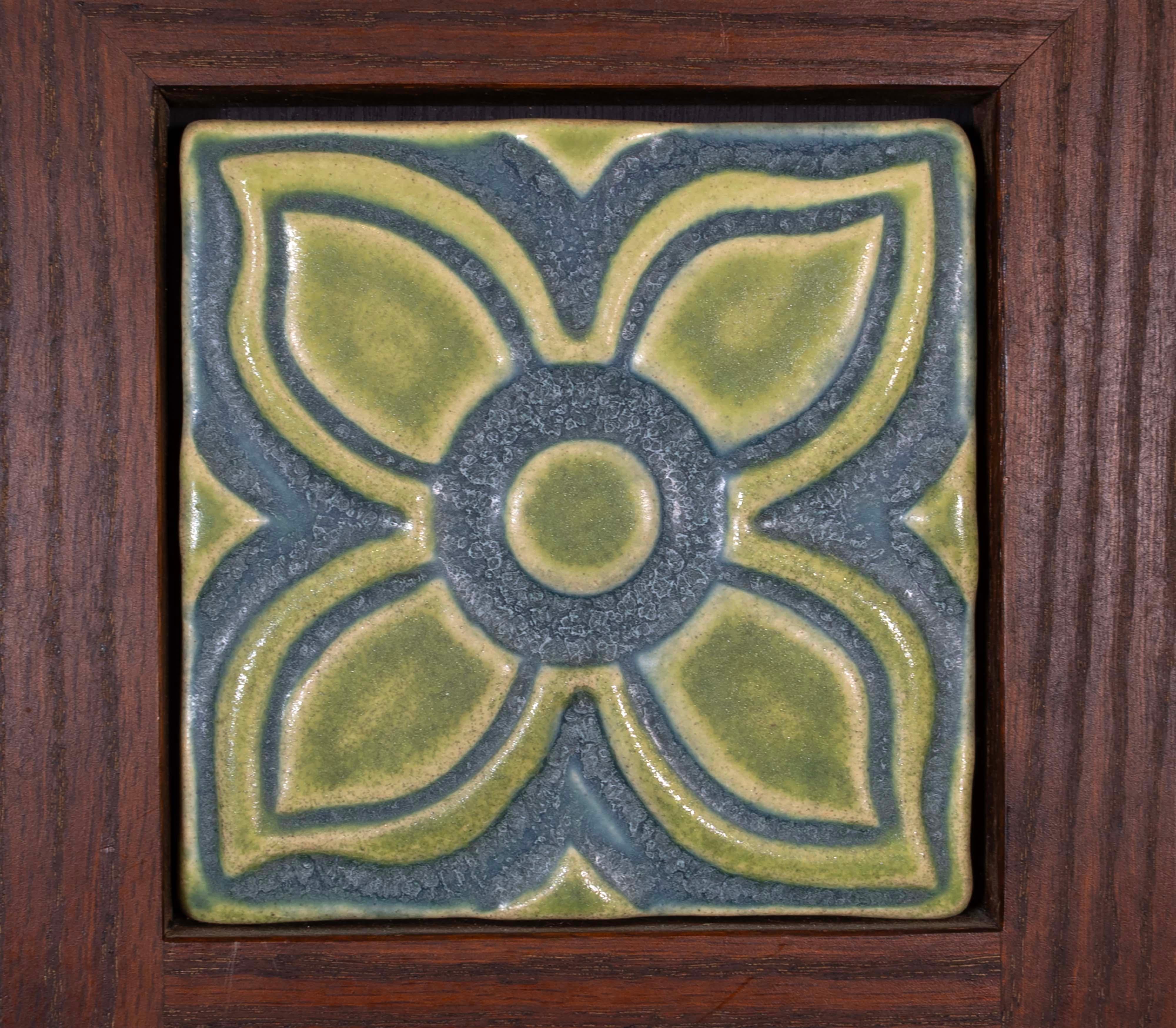 This beautiful framed pewabic triple flower tile set is a must-have for any home! Featuring soft earthy greens and delicate blues, this piece is sure to stand out in any space. In very good condition. Dimensions: 25.5