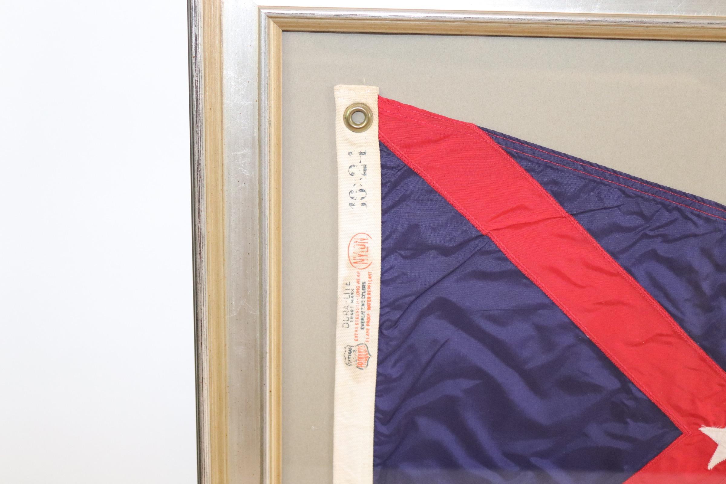 Framed yacht club burgee with blue field, red stripes, and white star. Weight is 10 pounds.